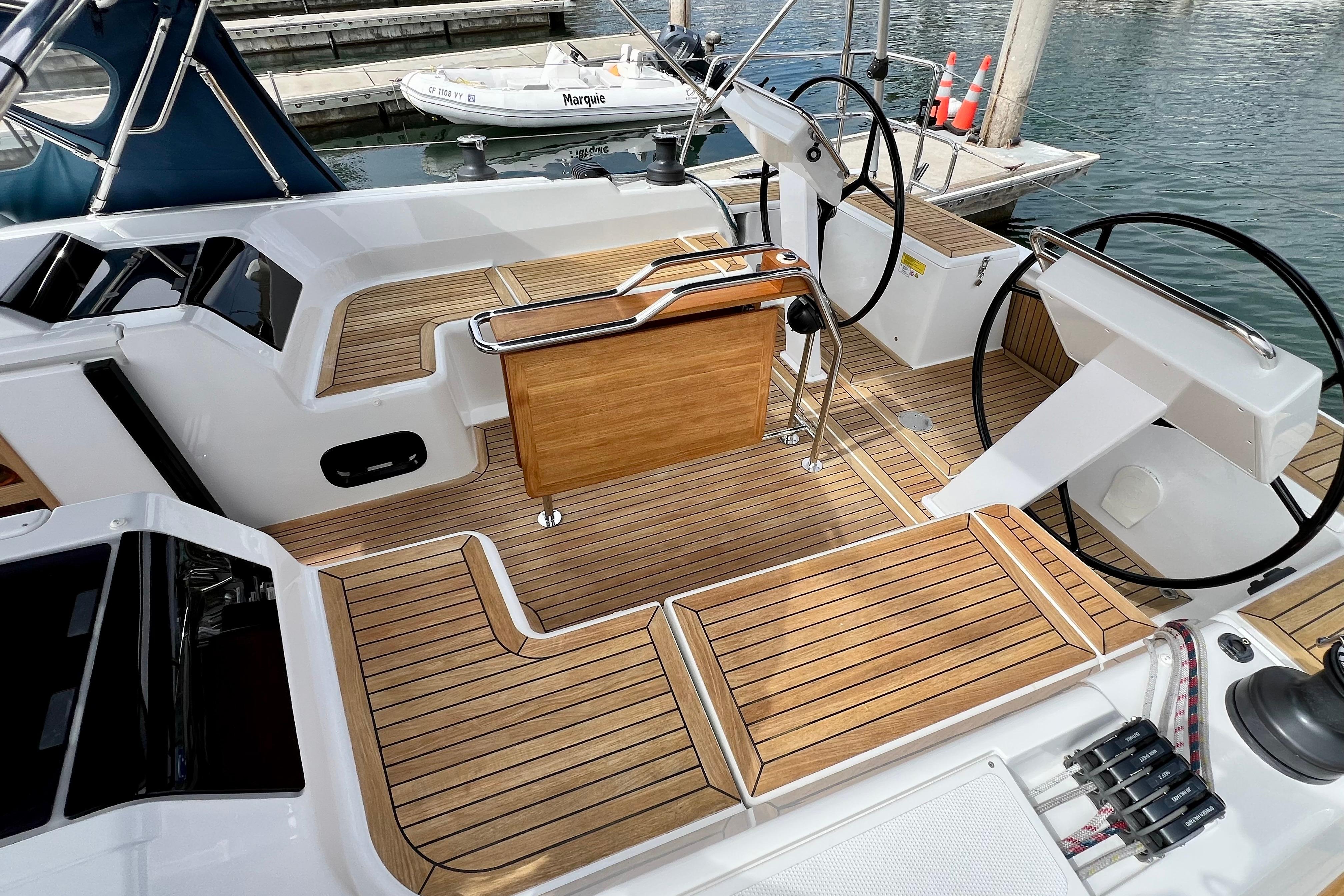 Cockpit of 2016 Hanse 455 yacht with dual steering wheels and teak flooring.