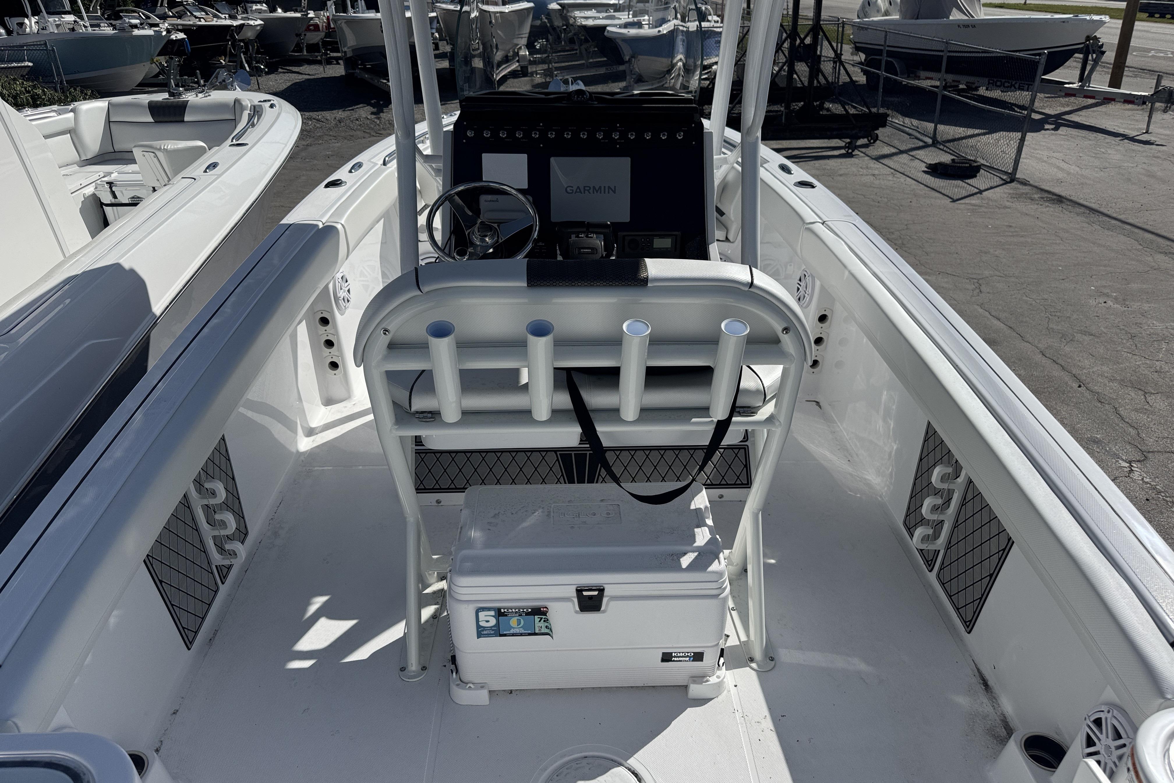 2025 Wellcraft 242 Fisherman boat interior with steering console and rod holders.