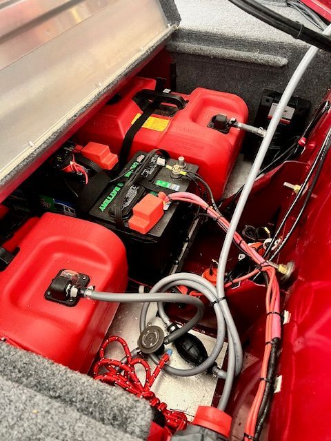 Battery compartment of 2022 Bass Tracker Classic XL with red tanks.