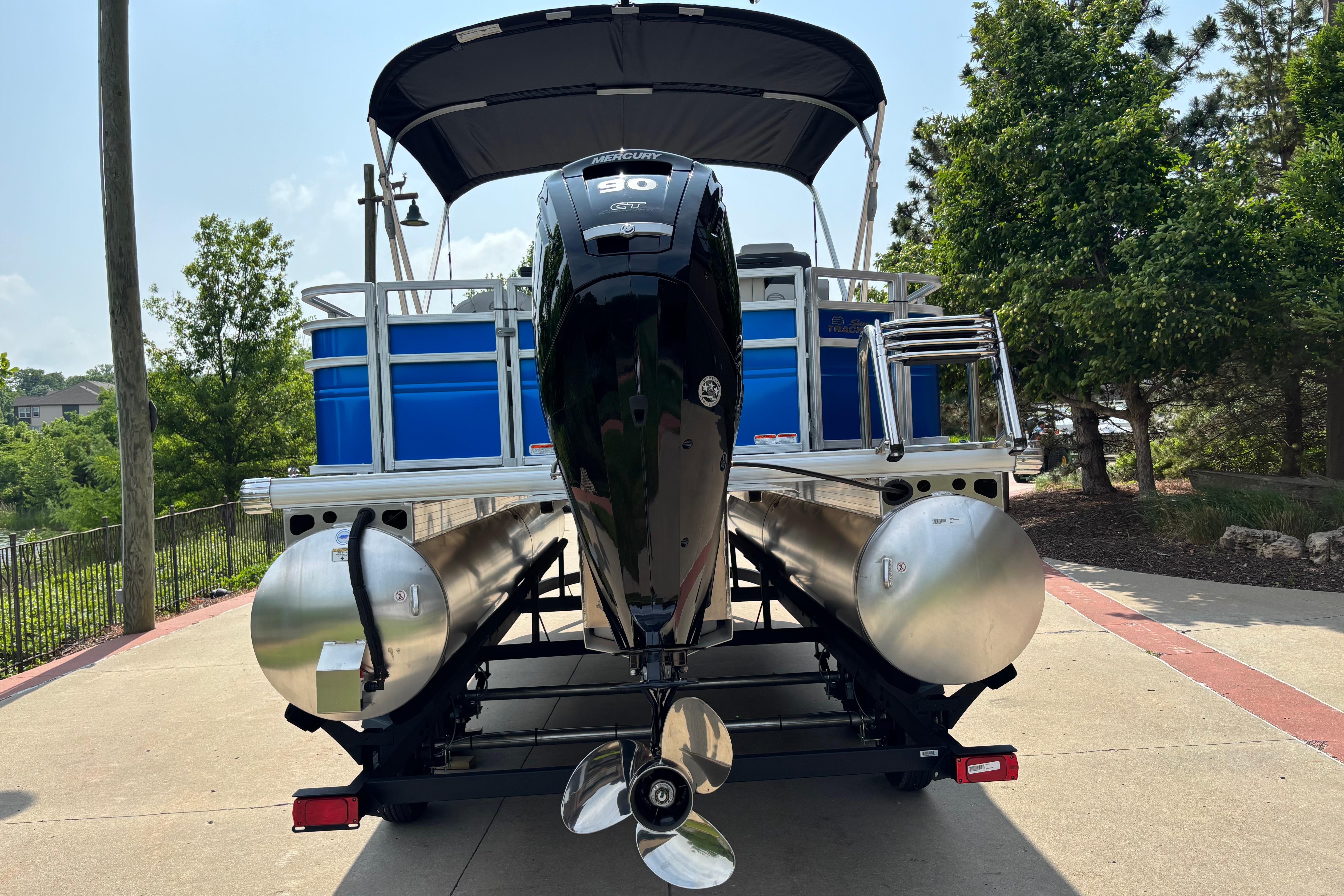 2026 Sun Tracker Fishin' Barge 20 DLX pontoon boat with Mercury outboard motor.