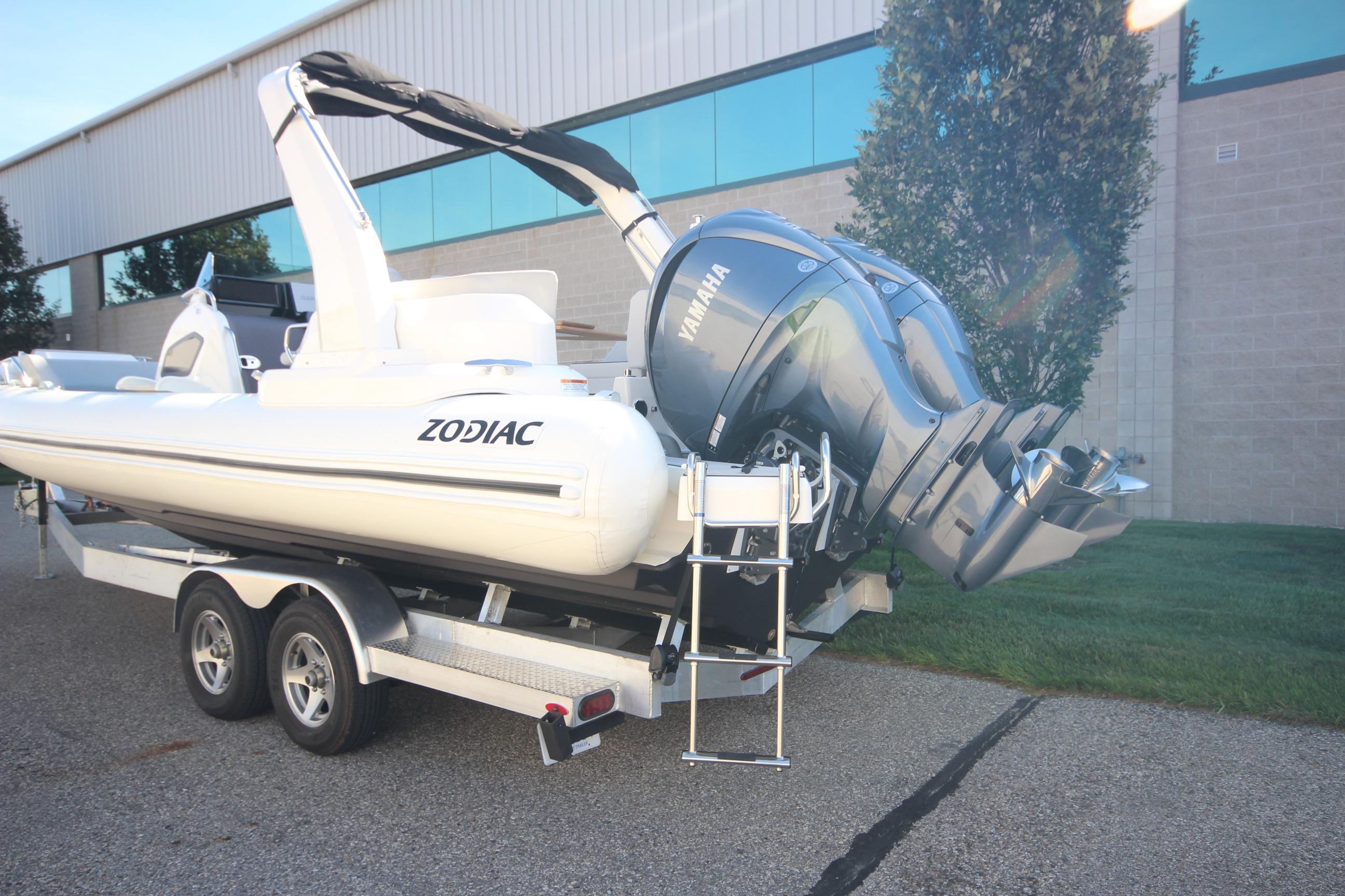 2024 Zodiac MEDLINE 9 NEO boat with twin 300hp engines on trailer, parked outdoors.