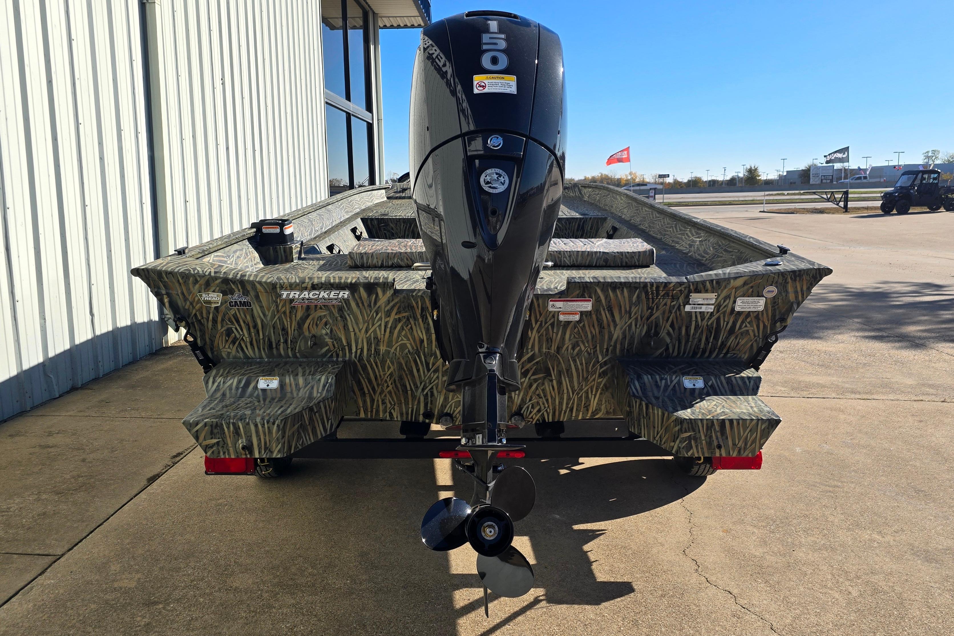 2026 Tracker Grizzly 2072 CC boat with camouflage design and 150 HP outboard motor.