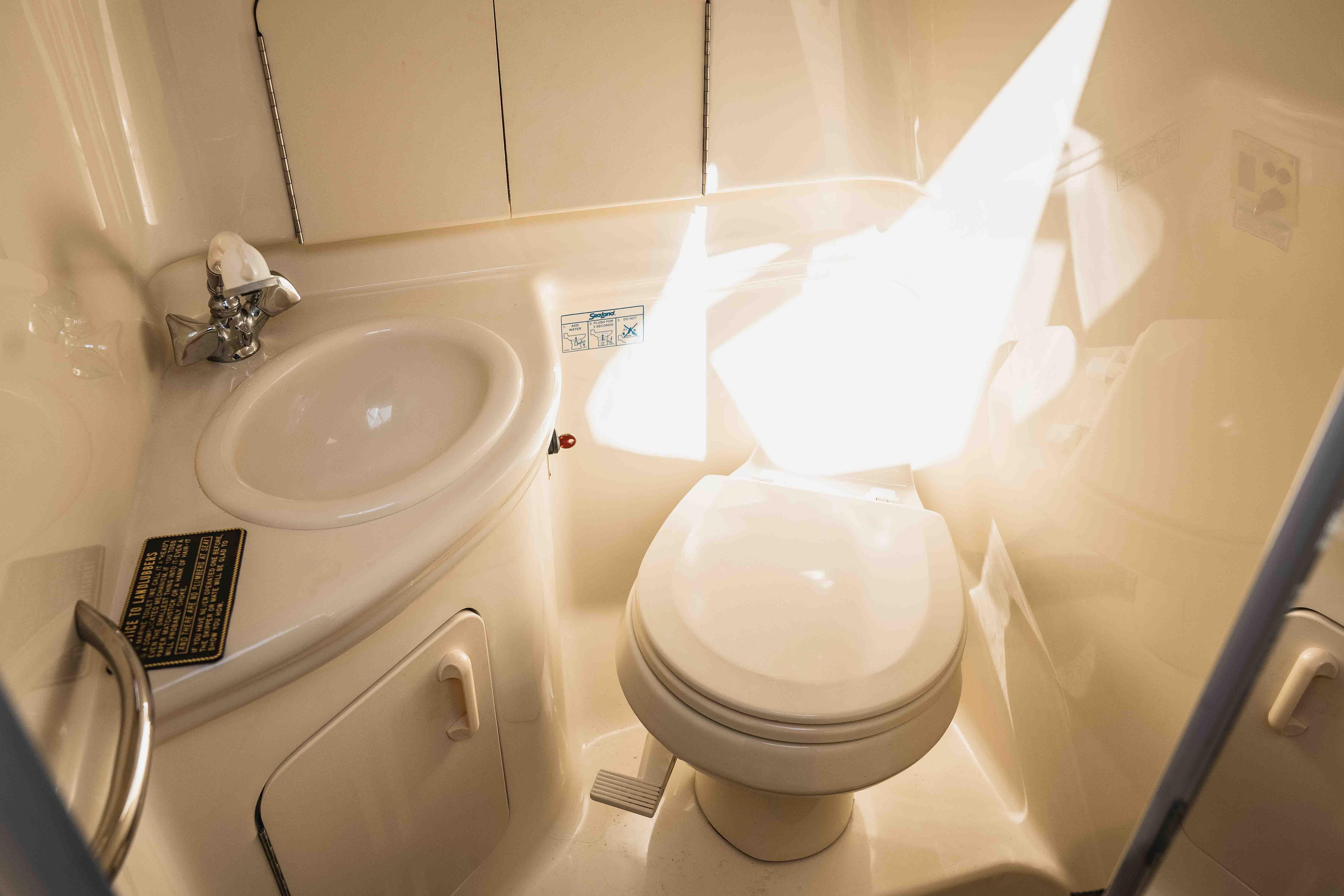 2006 Sea Ray Sundancer 280 bathroom with sink and toilet, well-lit interior.