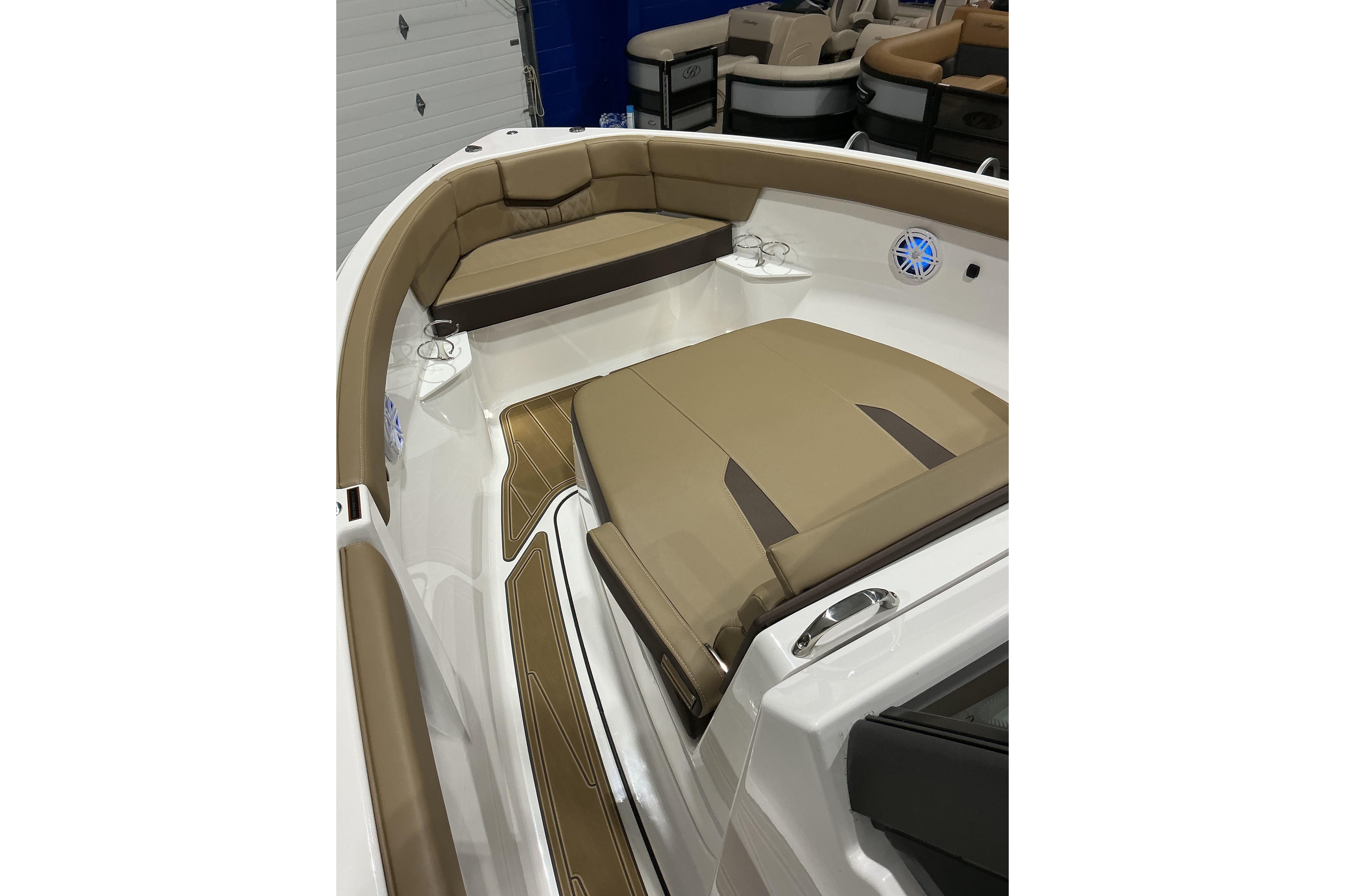 2026 Monterey Elite 25 SD boat interior with tan seating and cup holders.