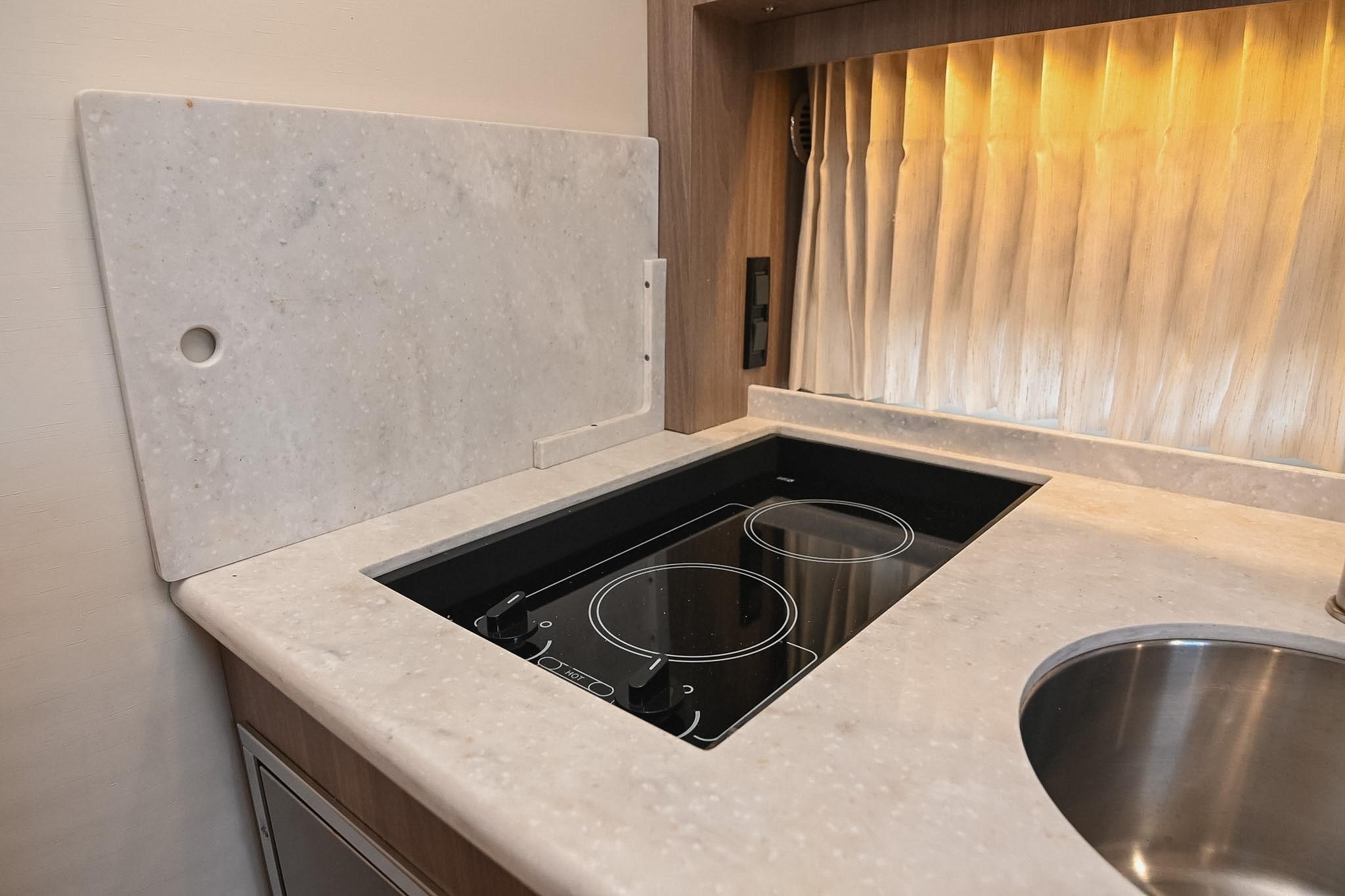 2021 Regal 33 Express yacht kitchen with induction cooktop and marble countertop.