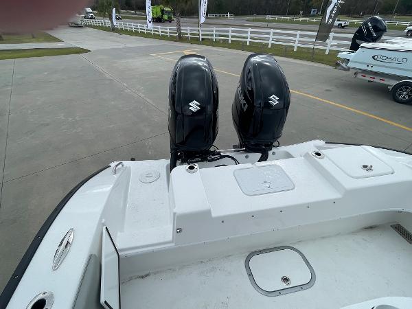 Cape Horn 24XS 2026 boat with dual Suzuki outboard motors, parked on a concrete surface.