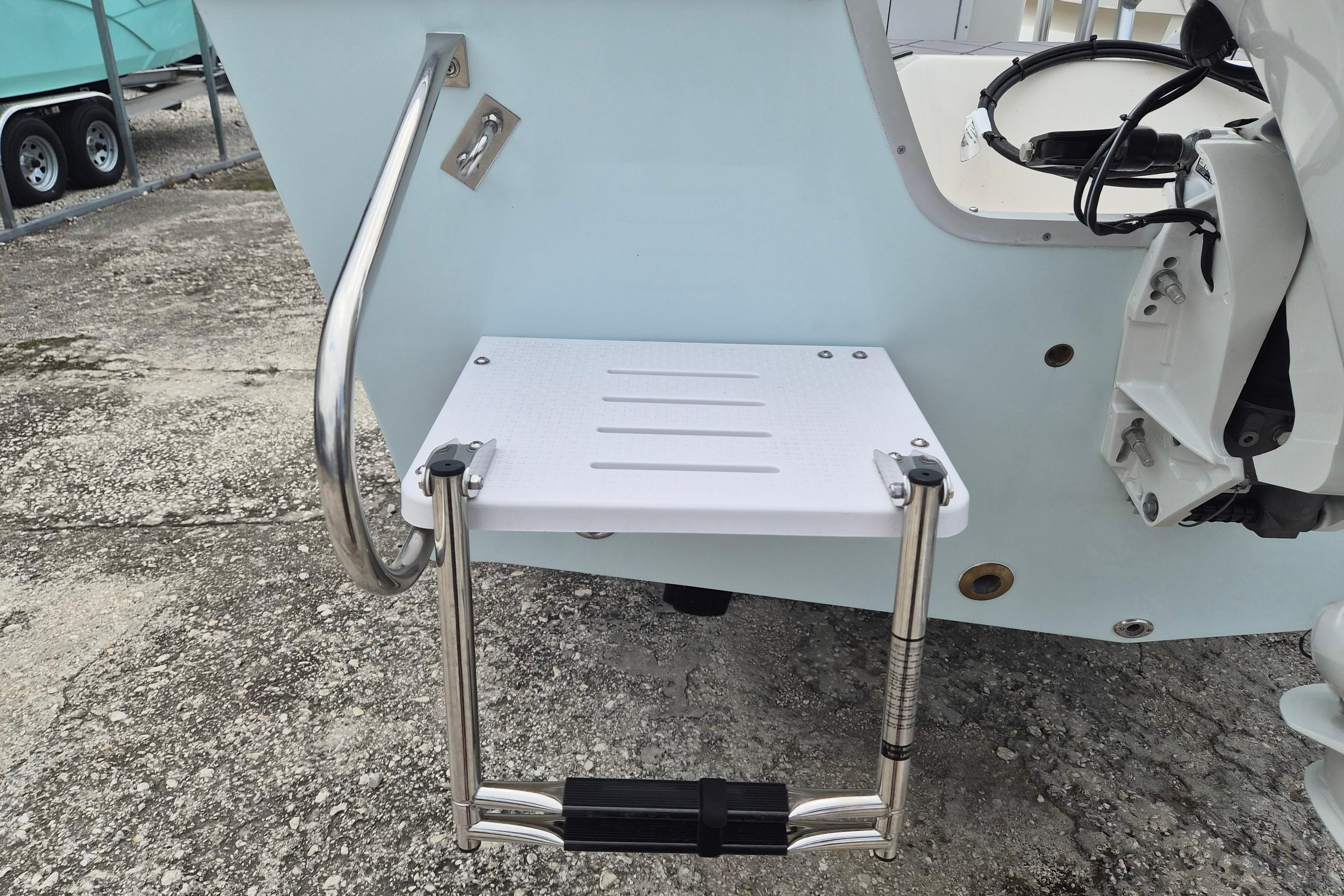 2026 Defiance Catalina 190 boat with swim platform and ladder on concrete surface.