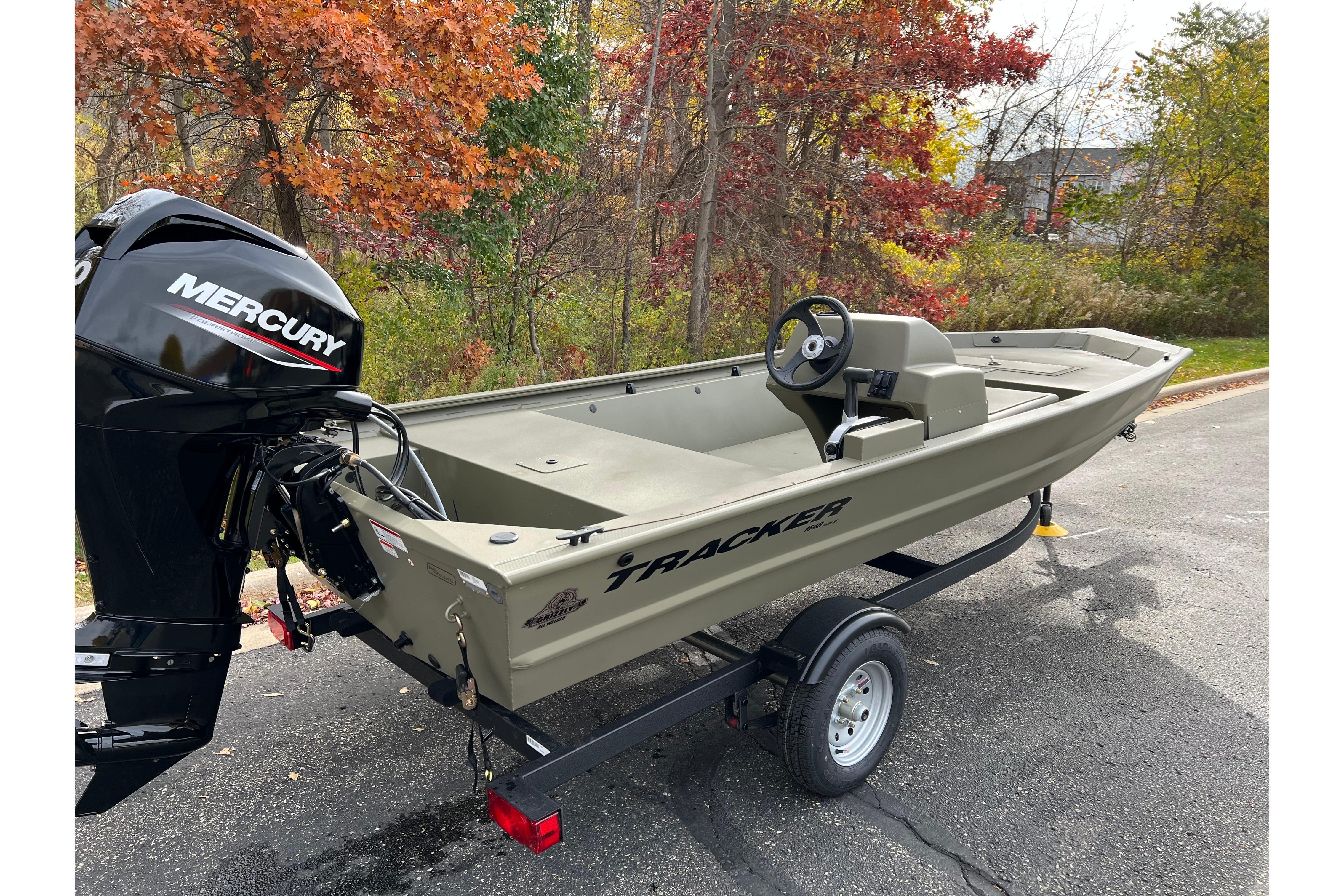 2026 Tracker Grizzly 1648 SC boat with Mercury engine on a trailer, autumn background.