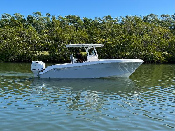 2022 Aquasport 2500 Center Console on calm water.