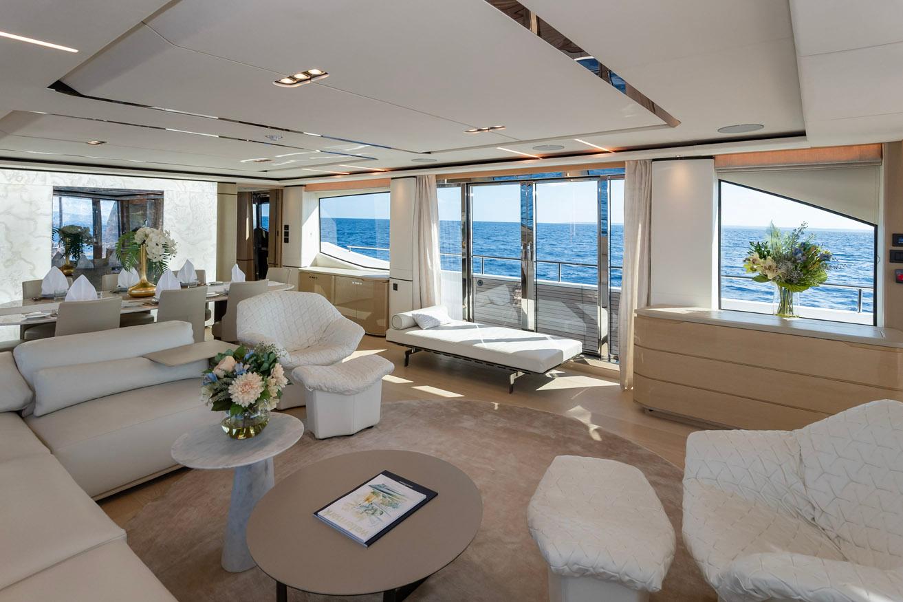 Luxurious interior of 2019 Princess 30M yacht with ocean view, elegant seating, and floral decor.