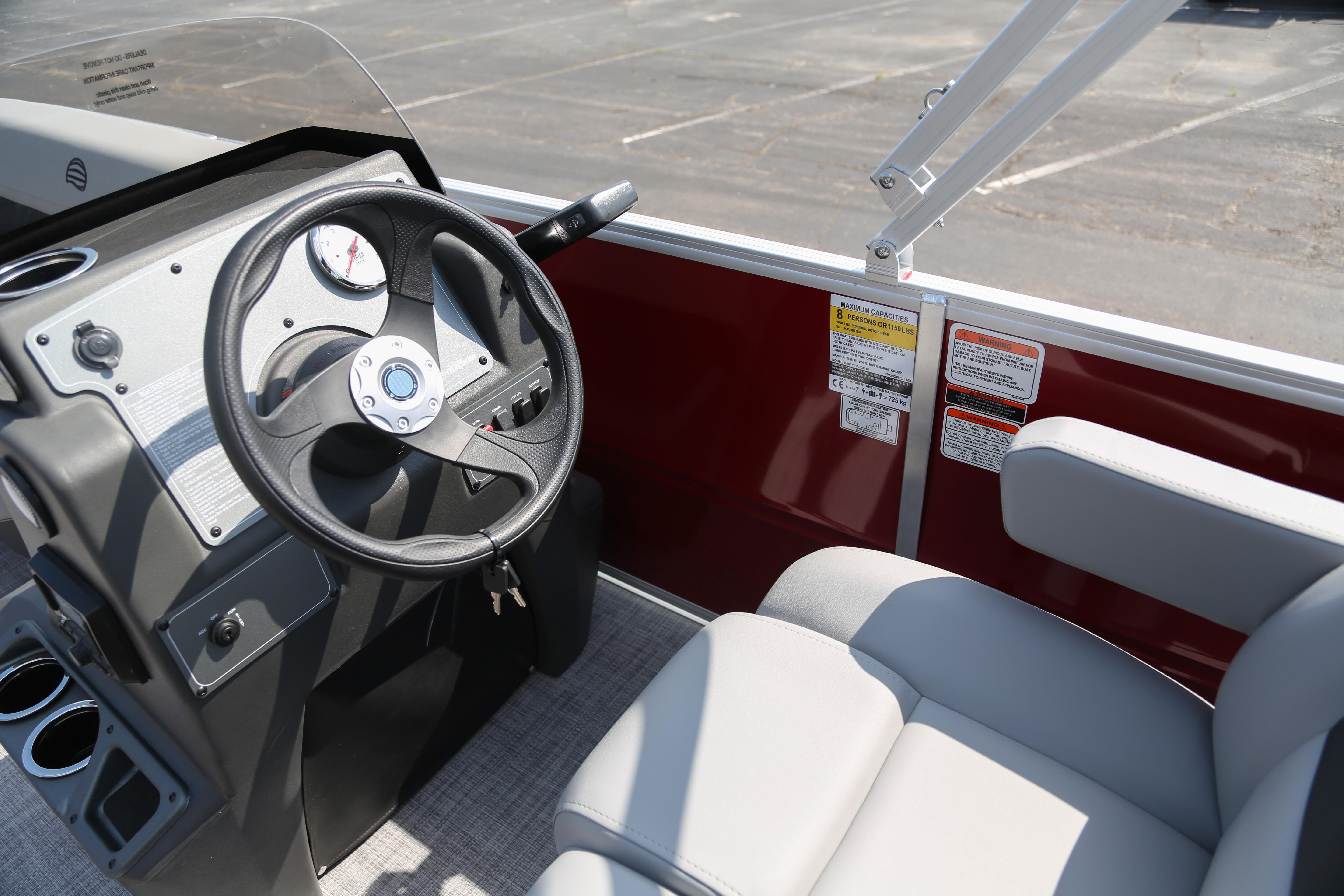 2026 Sun Tracker Party Barge 16 DLX steering console with comfortable seating and modern controls.