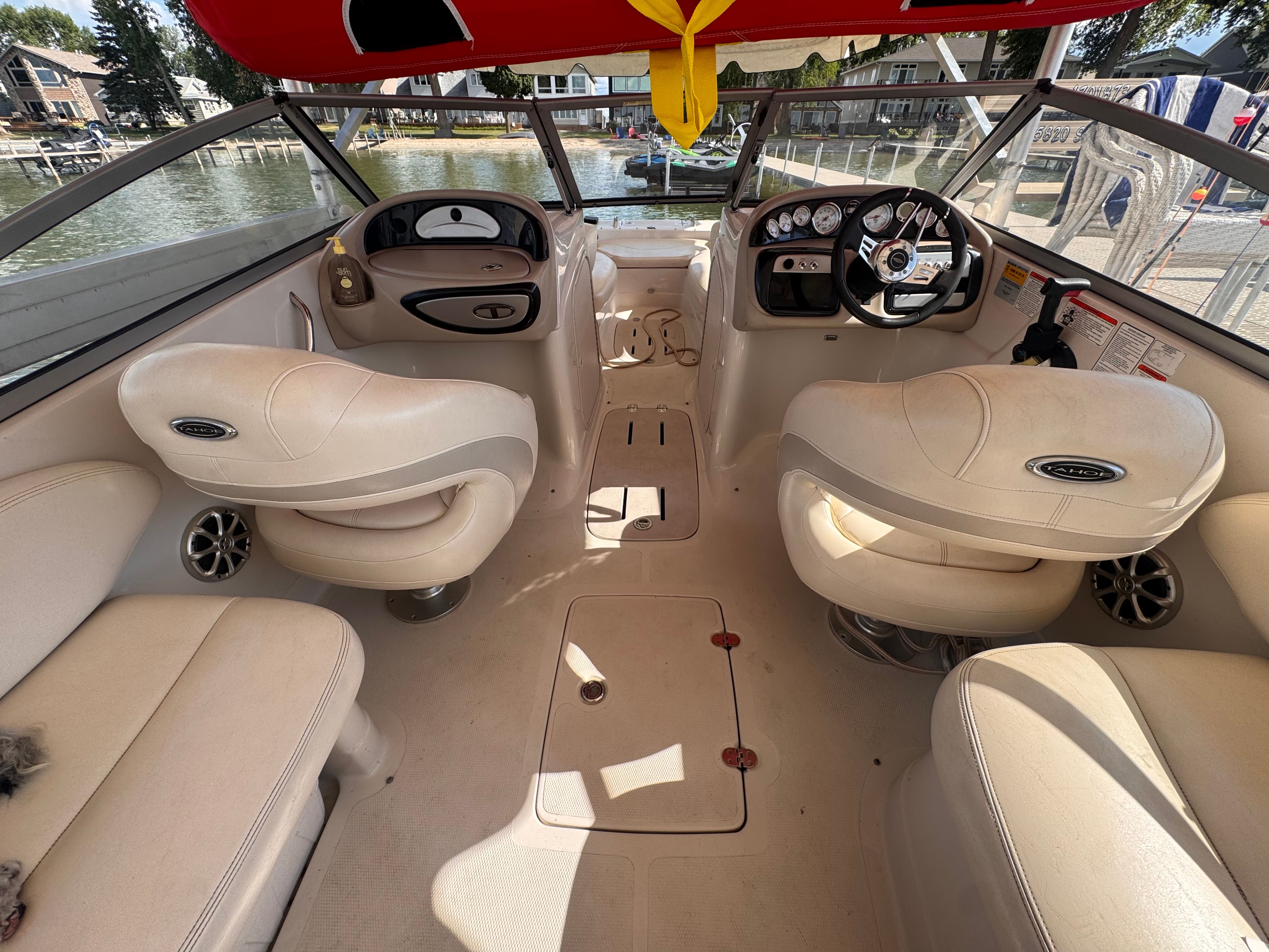 Interior of a 2011 Tahoe 228 with beige seating and a sleek dashboard.