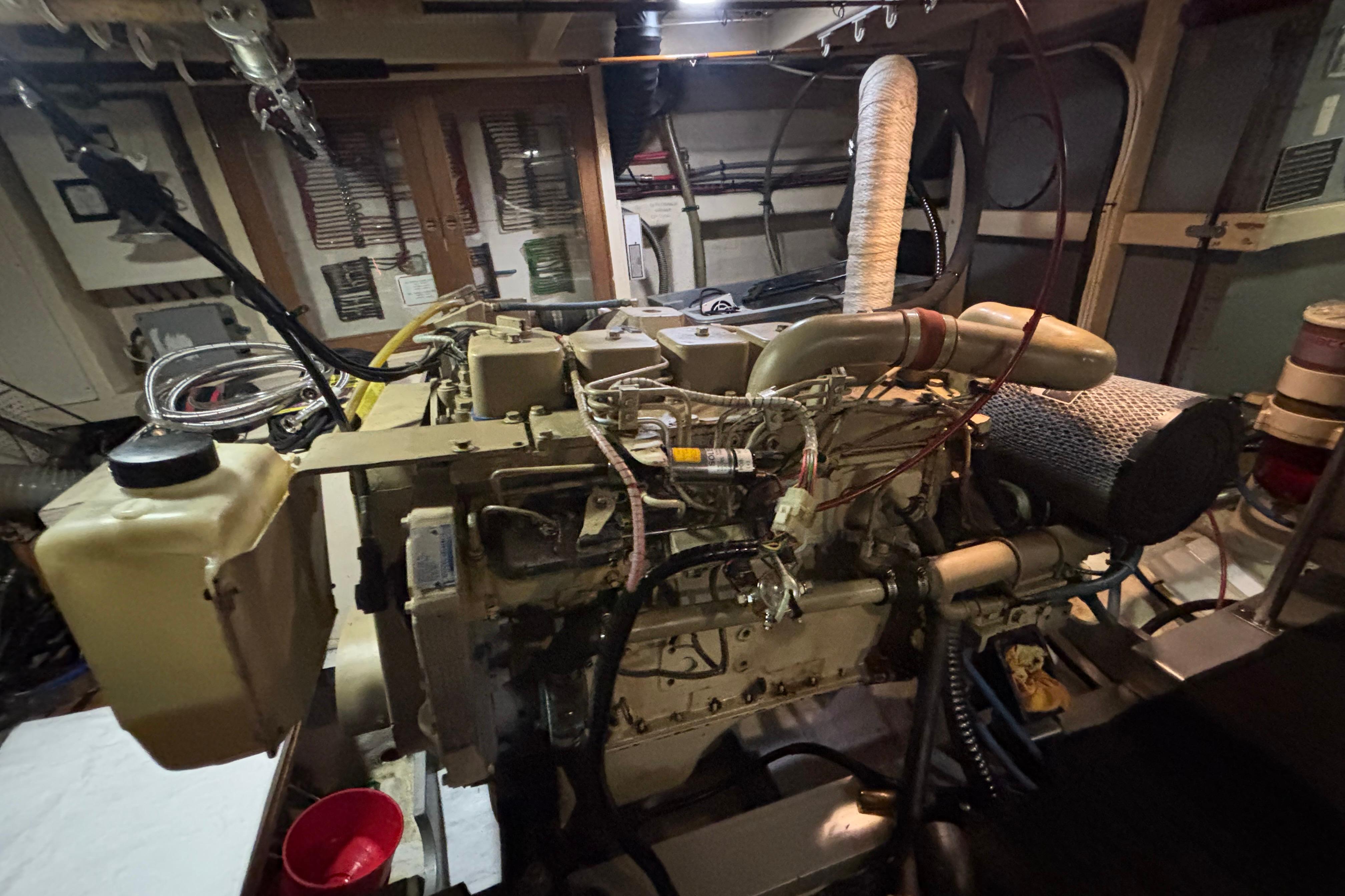 Engine room of a 1989 Grand Banks 46 Classic yacht, showcasing detailed machinery.
