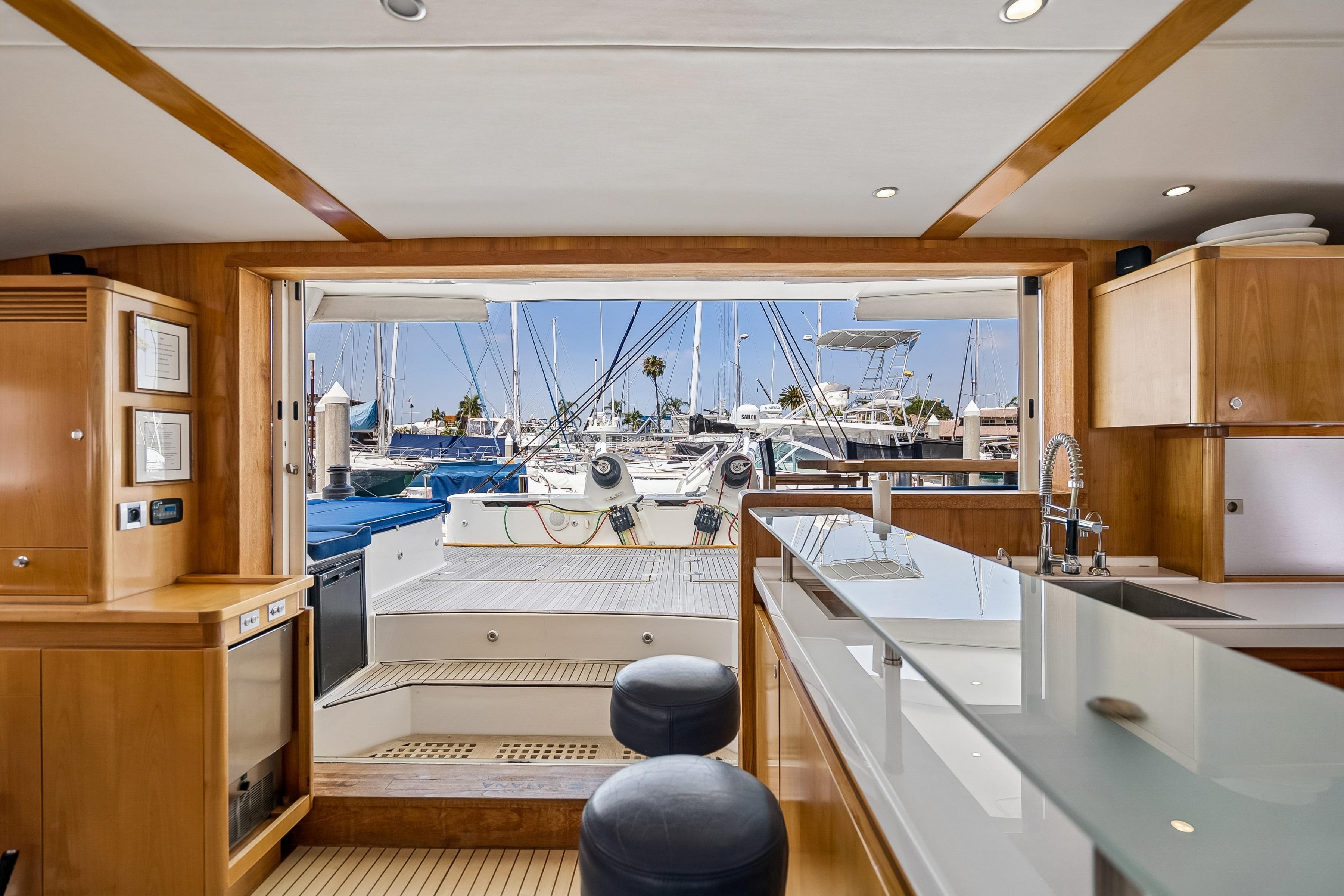 Interior view of 2009 Catana 65 yacht with modern kitchen and marina backdrop.