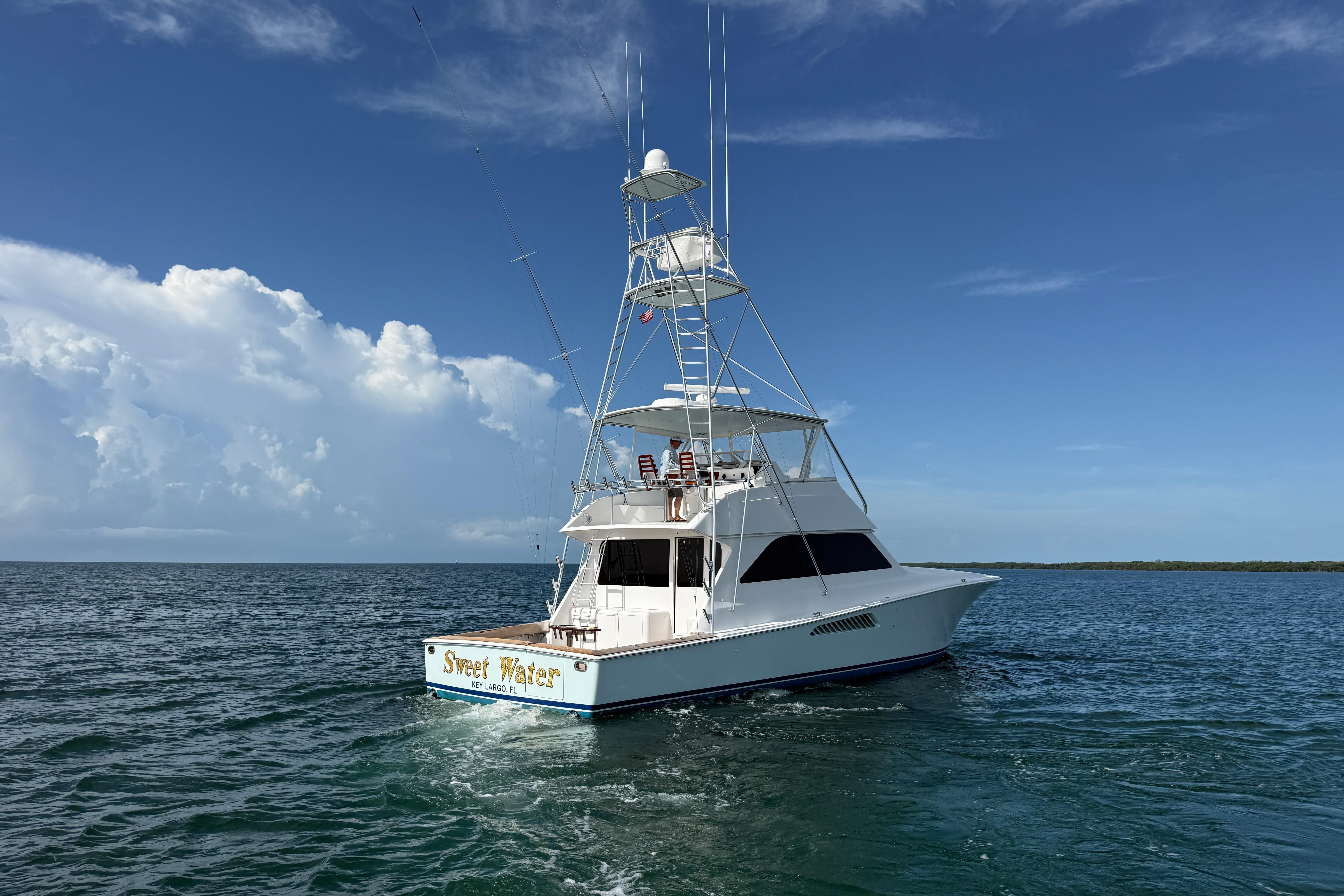 Viking 55 Convertible yacht from 2000 on open water under clear skies.