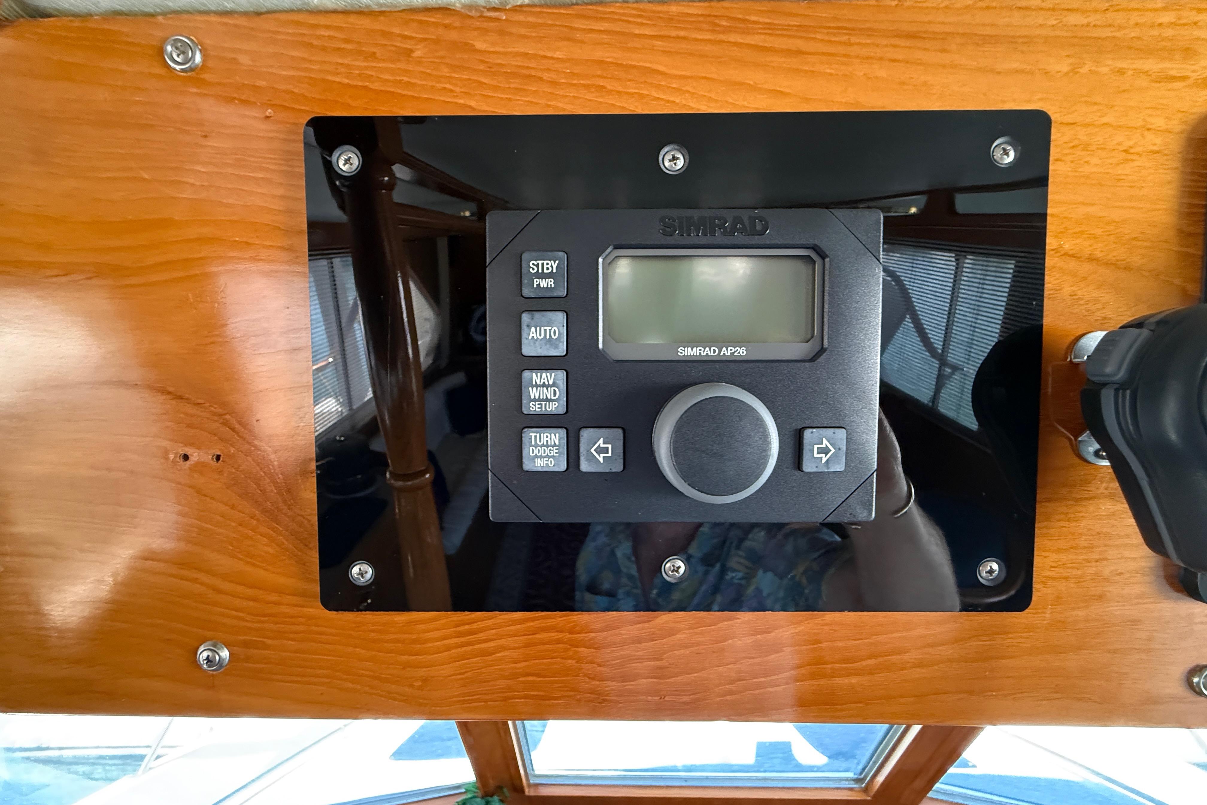 Simrad AP26 autopilot on 1987 PT Sundeck boat's wooden dashboard.