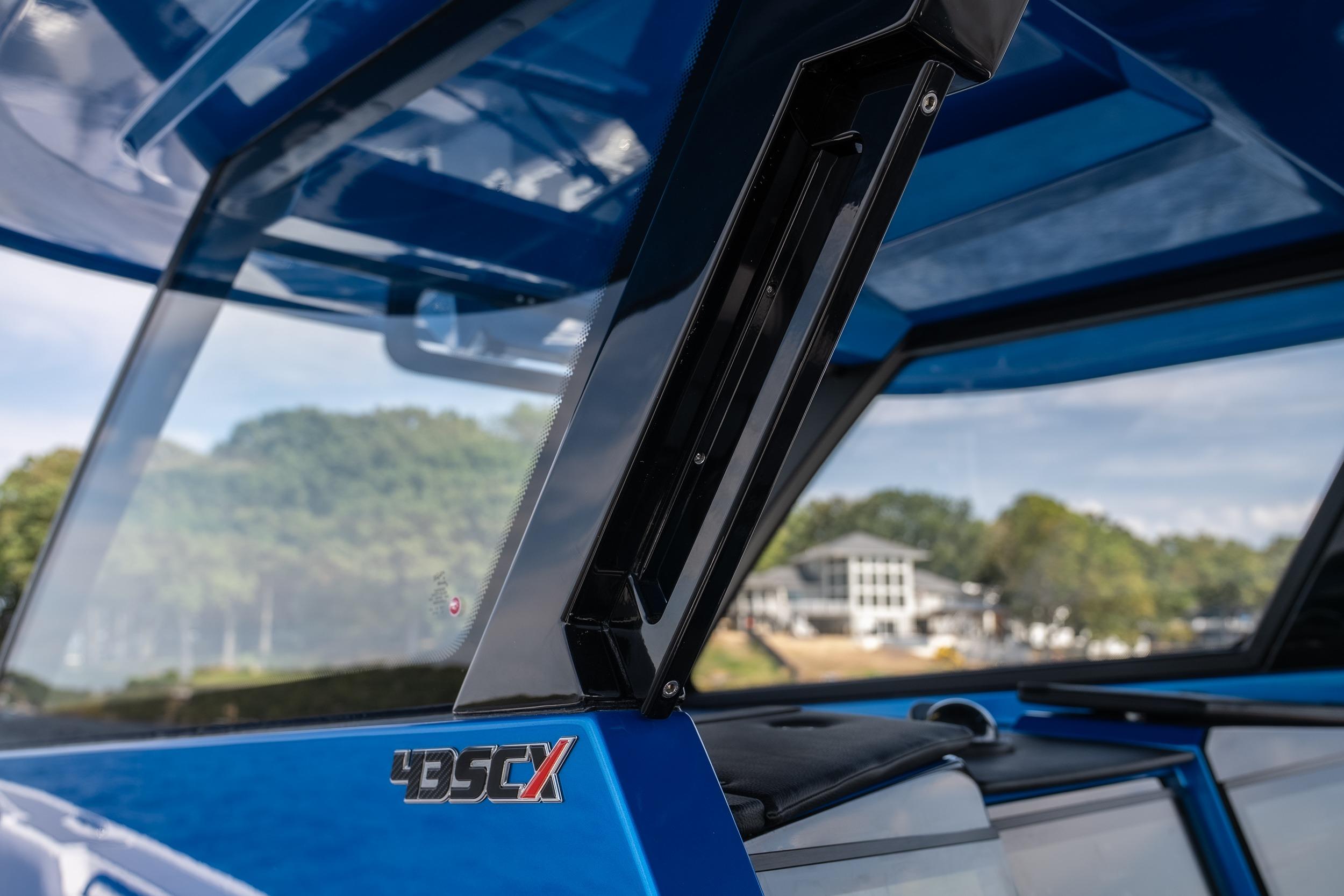 2026 Fountain 43 SCX boat windshield detail with scenic background.
