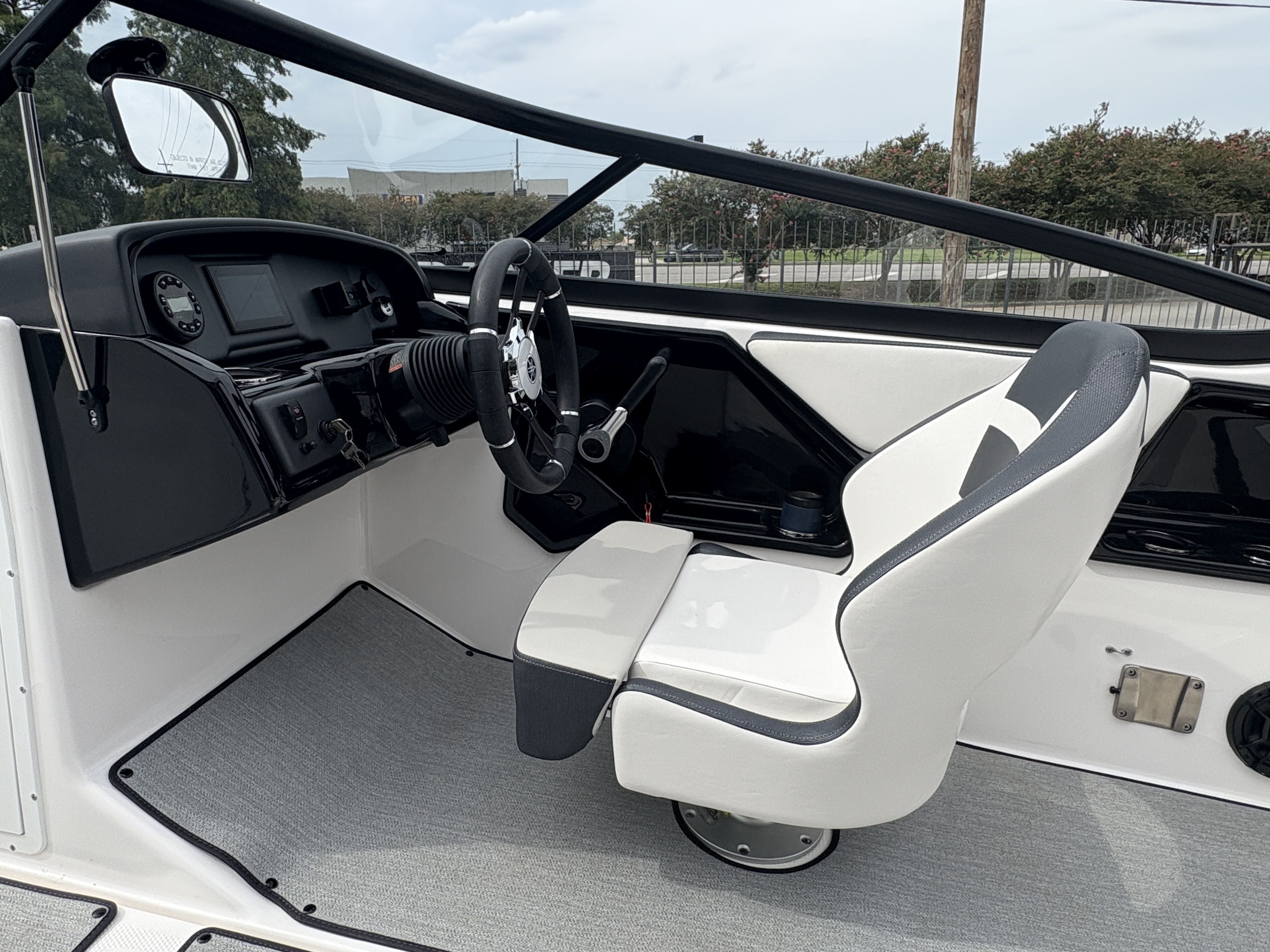 2024 Yamaha Boats AR 195 interior with steering wheel and captain's chair.