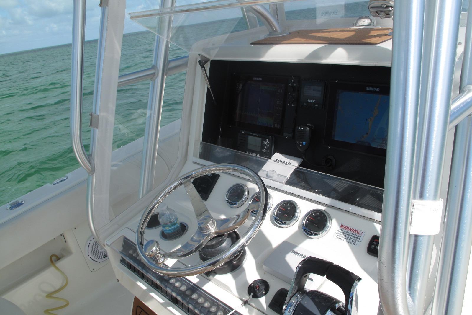 2017 SeaVee 340B boat helm with navigation screens and steering wheel.