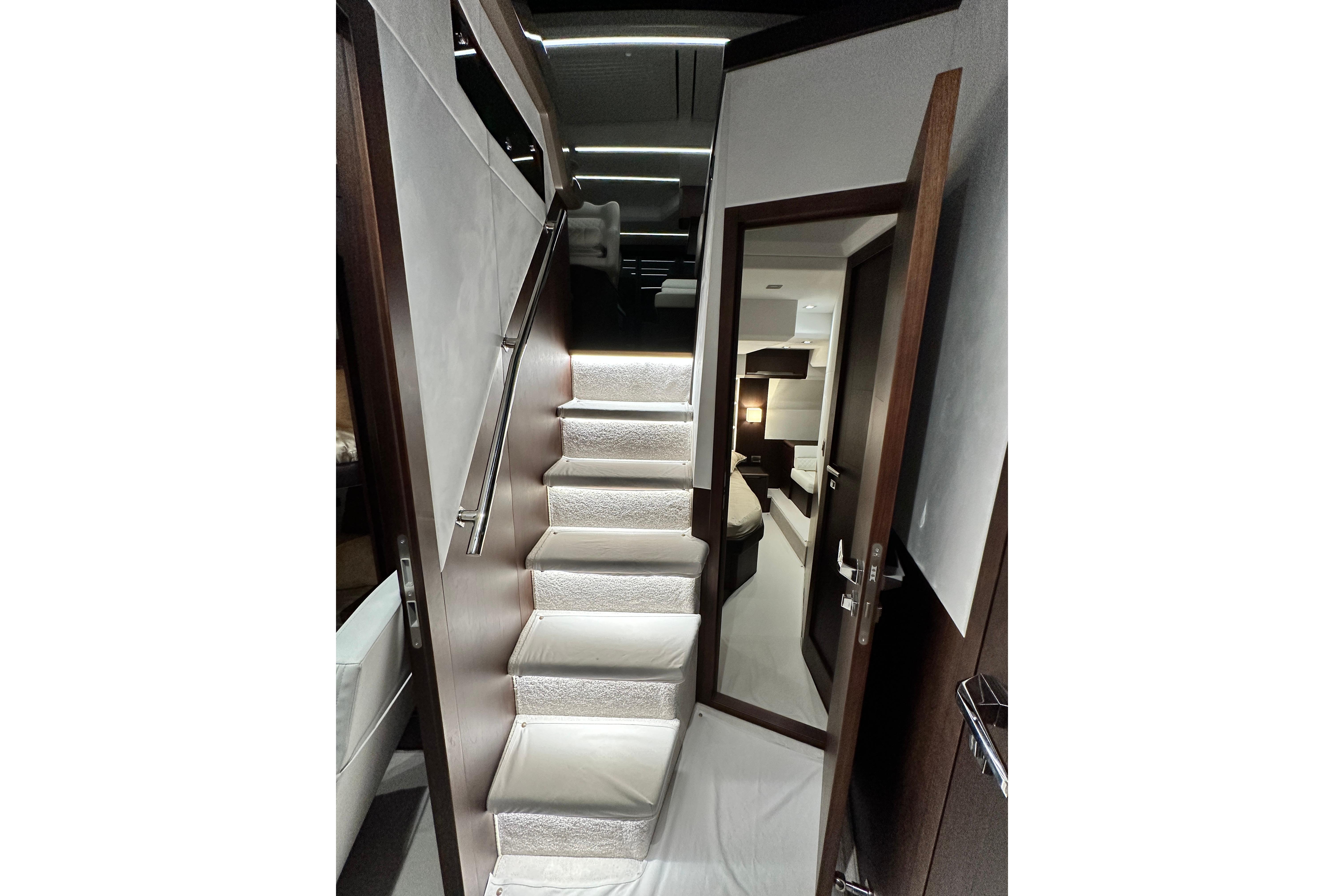 Interior staircase of 2022 Galeon 470 Sky yacht, featuring modern design and luxurious finishes.