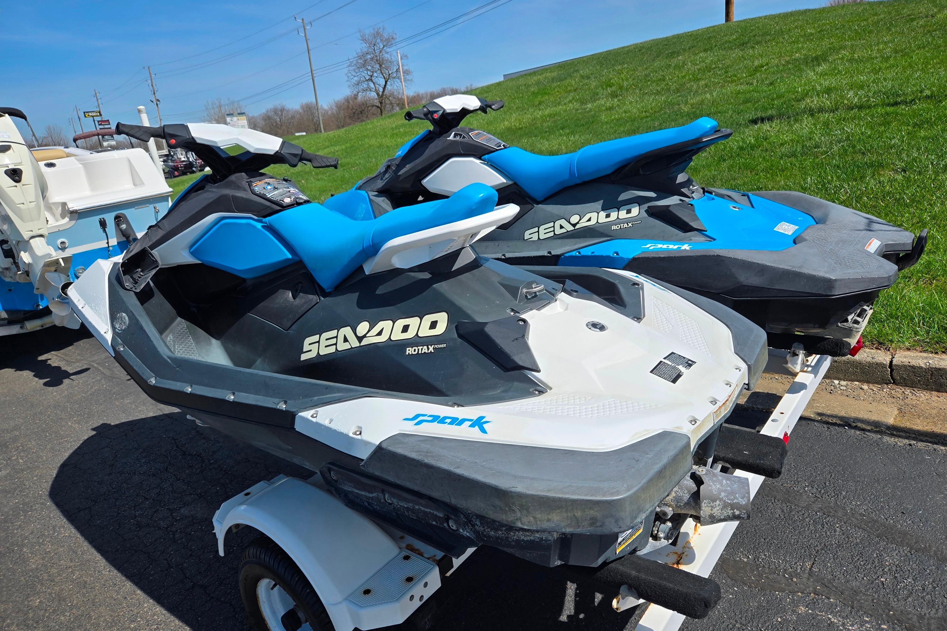 2020 Sea-Doo Spark 2up jet skis on trailer, parked on pavement.