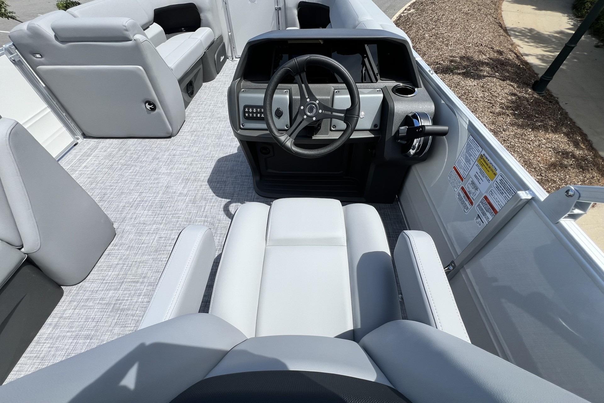 2026 Sun Tracker Party Barge 20 DLX interior with modern helm and comfortable seating.