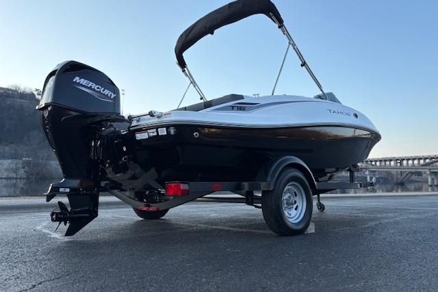 2026 Tahoe T16 boat with Mercury engine on trailer, parked outdoors.