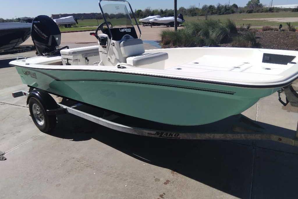 2026 Mako Pro Skiff 15 CC boat on trailer, parked outdoors.