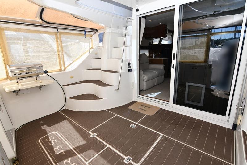 Interior of 2008 Carver 43 Super Sport yacht with stairs and sliding glass door.