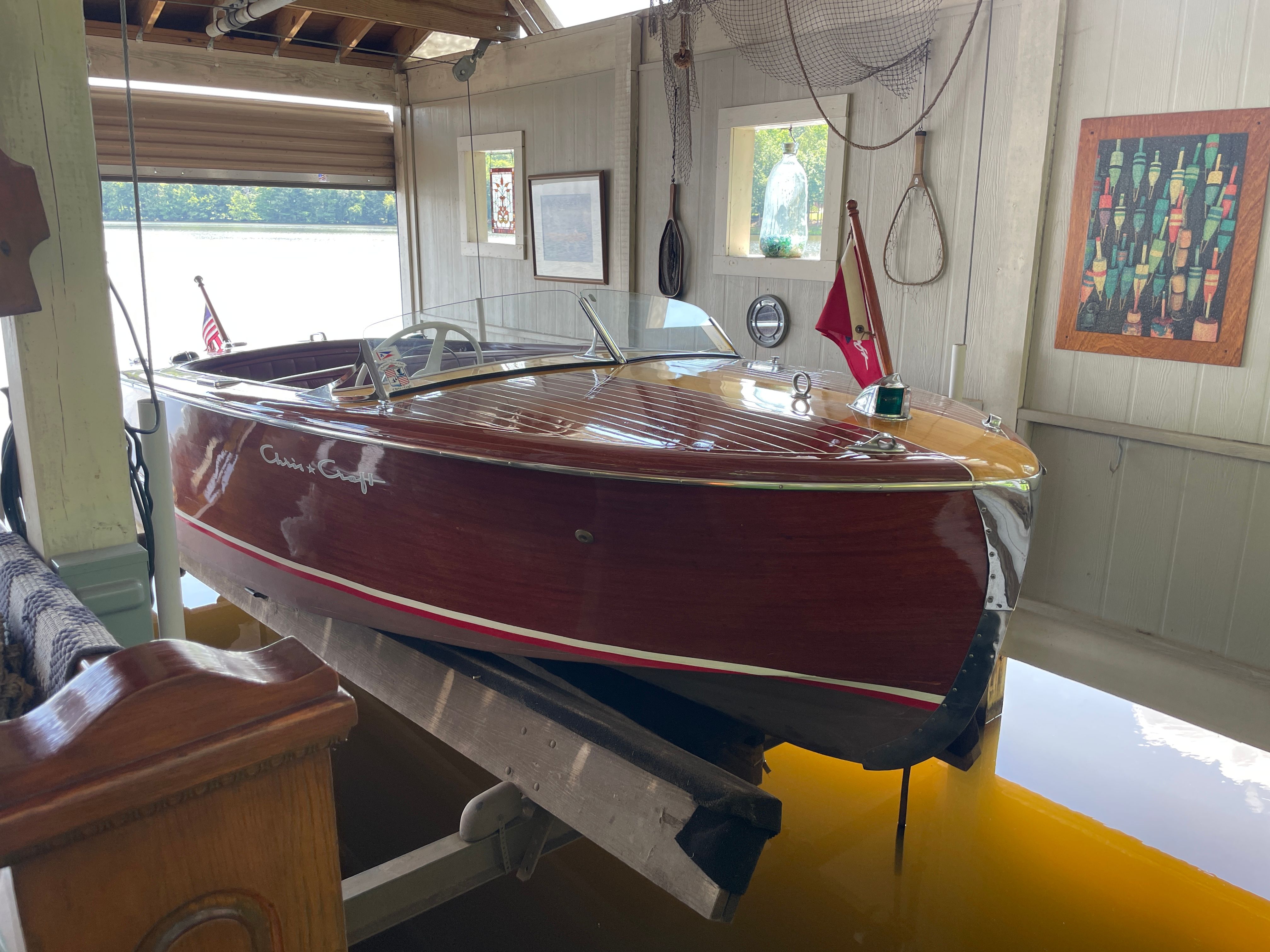 1954 Chris-Craft Riviera wooden boat in a boathouse.