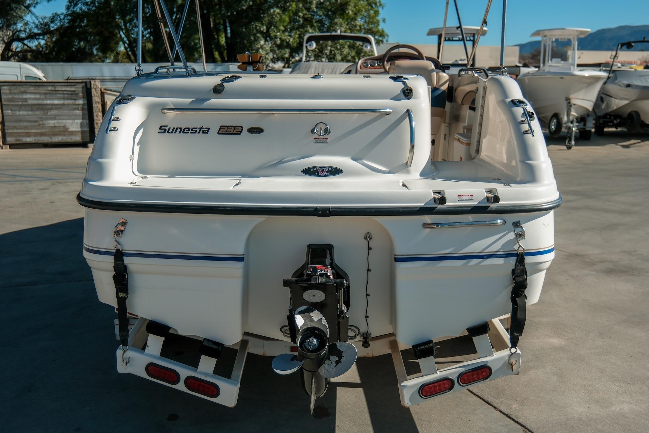 1998 Chaparral 232 Sunesta boat rear view in a marina setting.