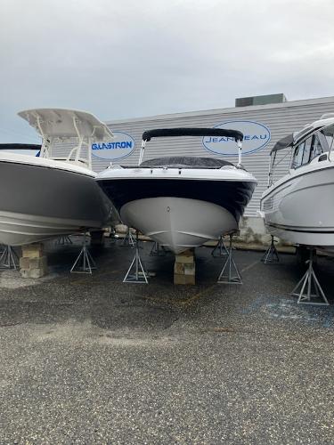 2024 SouthWind 2400 SD boat on stands between other boats in a marina.