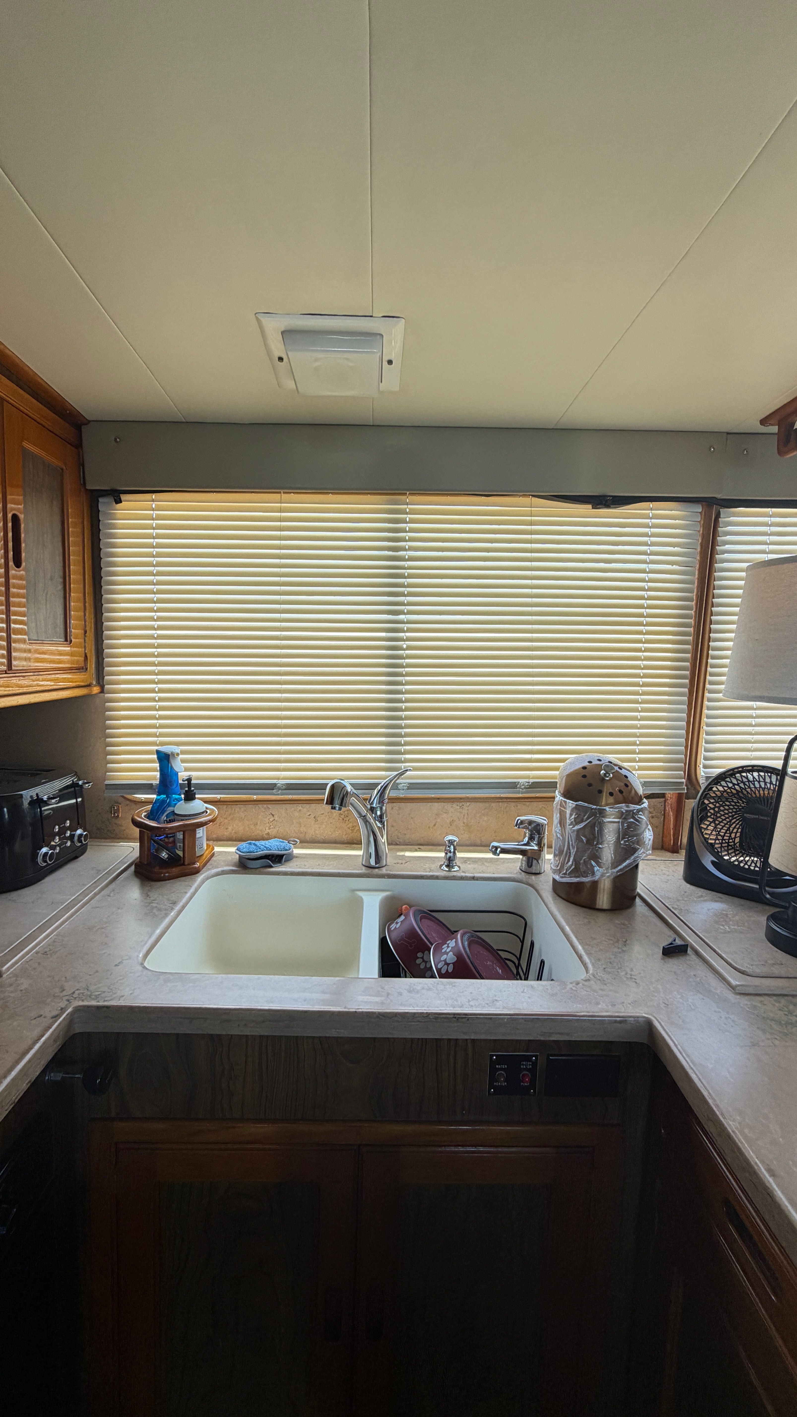Interior of a 1966 Drake Yachtfisher with sink and window.