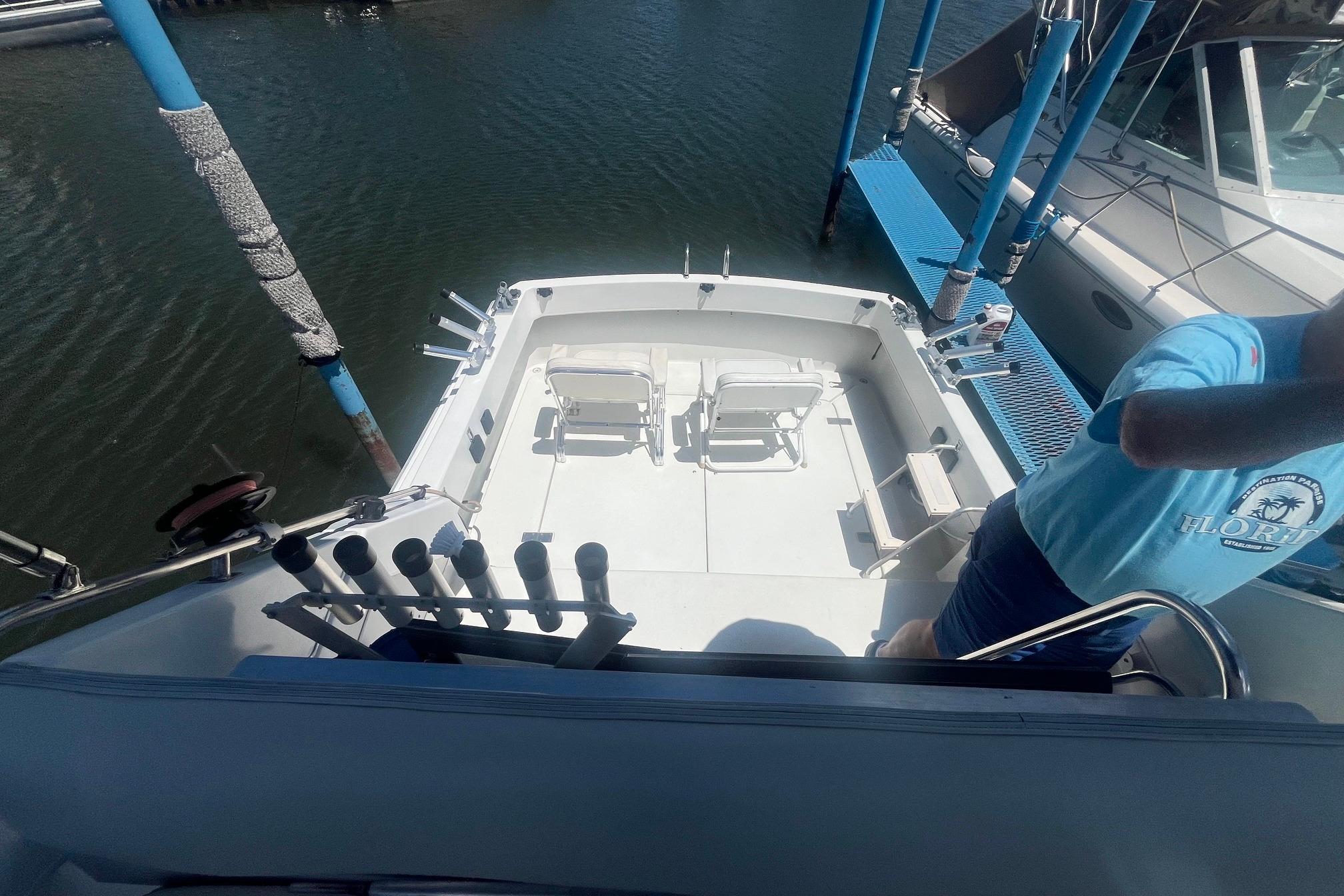 1988 Seafox 29 Flybridge boat deck with fishing rod holders and chairs.