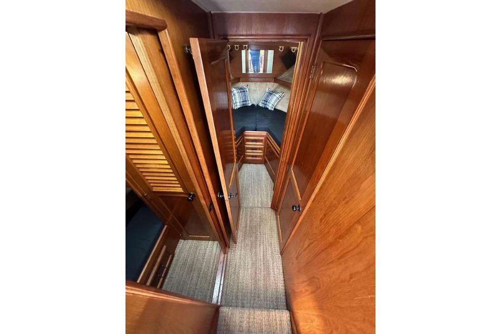 Interior view of 1985 Egg Harbor 33 Sedan, featuring wood paneling and cozy cabin space.