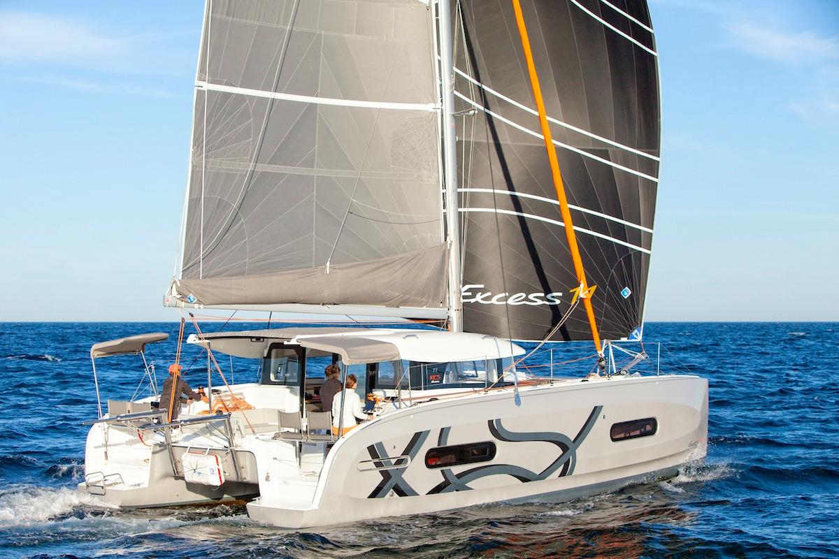 2026 Excess 11 catamaran sailing on open sea with modern design and spacious deck.