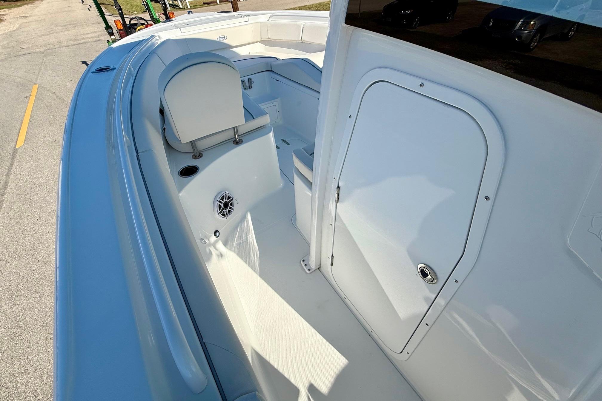 2026 Sea Hunt Ultra 255 SE boat interior with seating and storage compartment.