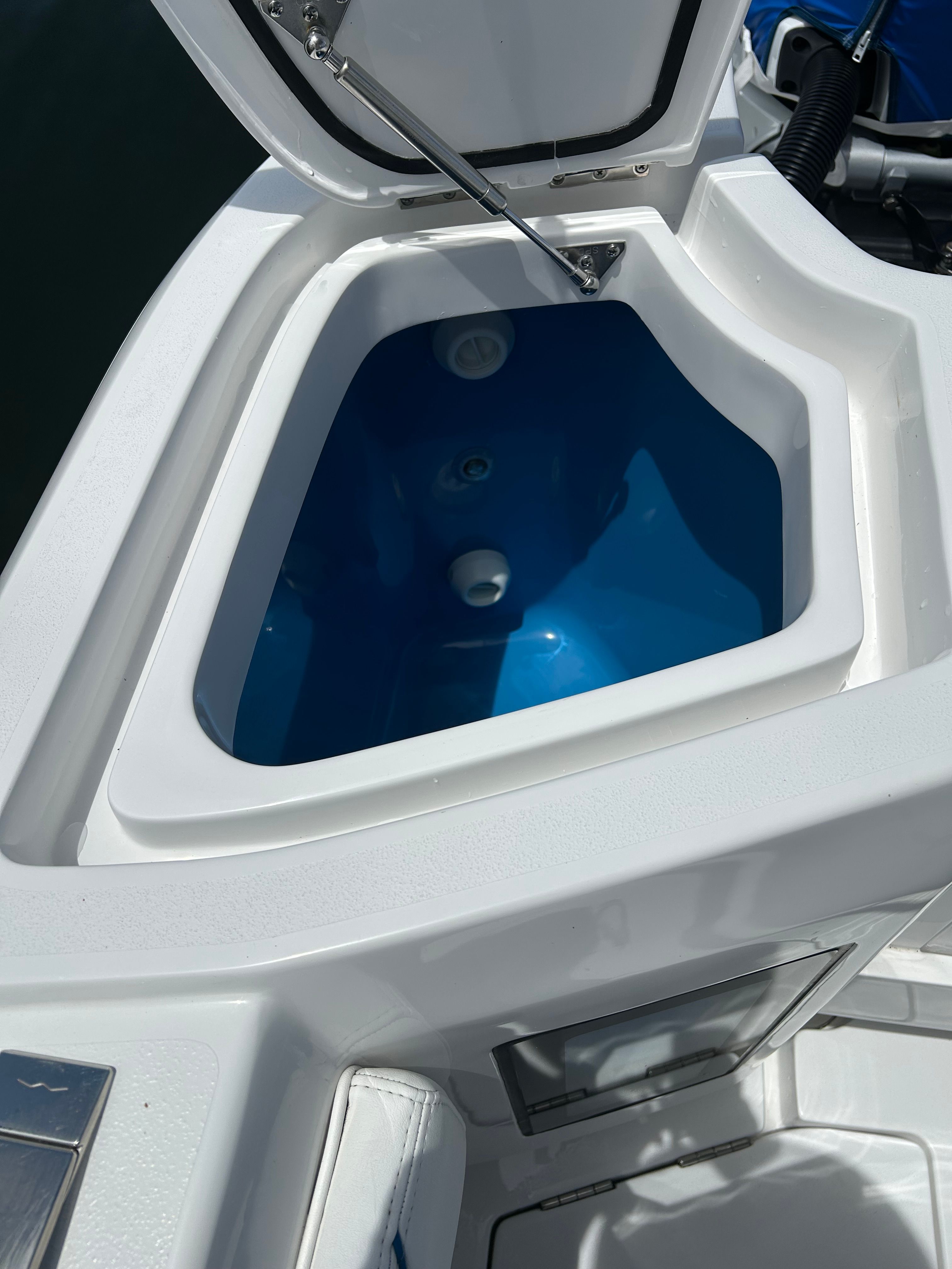 Intrepid 375 Nomad SE 2025, open storage compartment on a boat.
