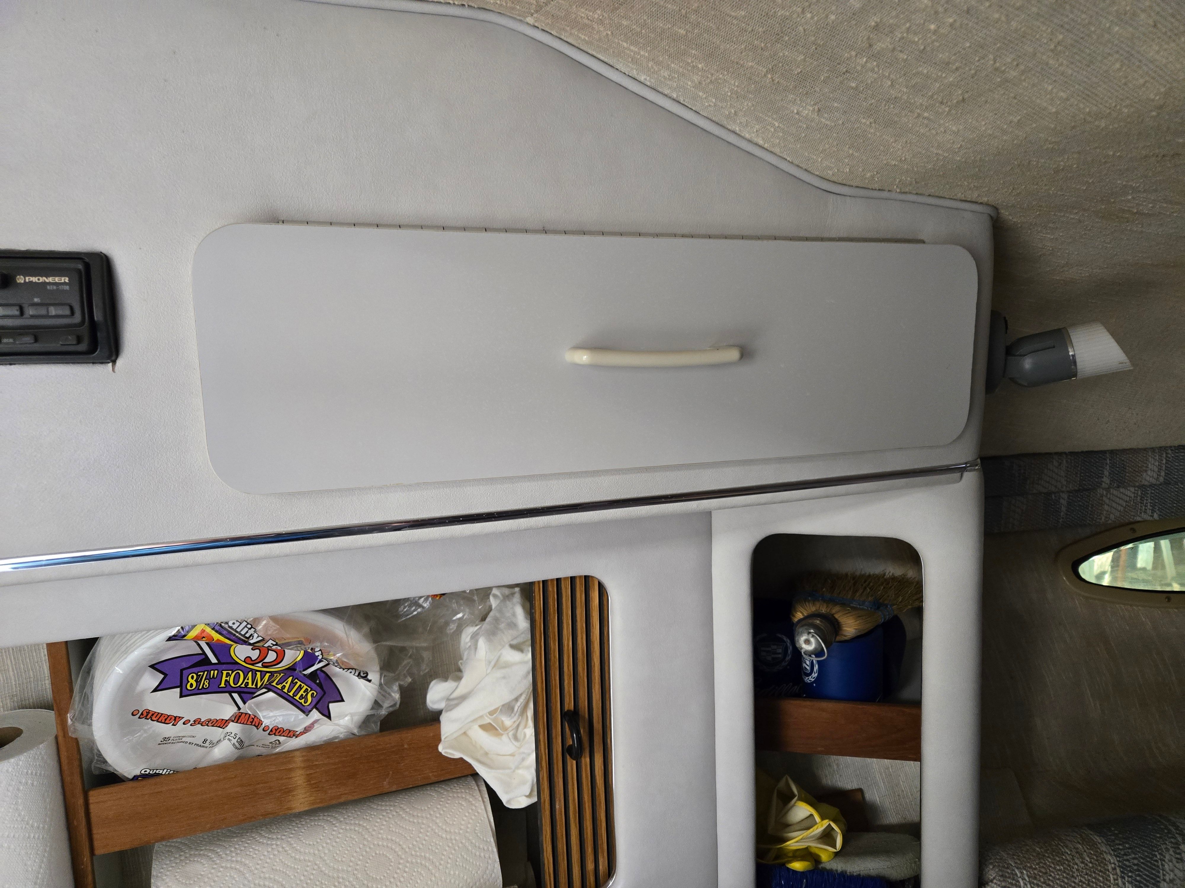 Interior of a 1991 Sea Ray 250 Weekender with storage compartments and shelves.