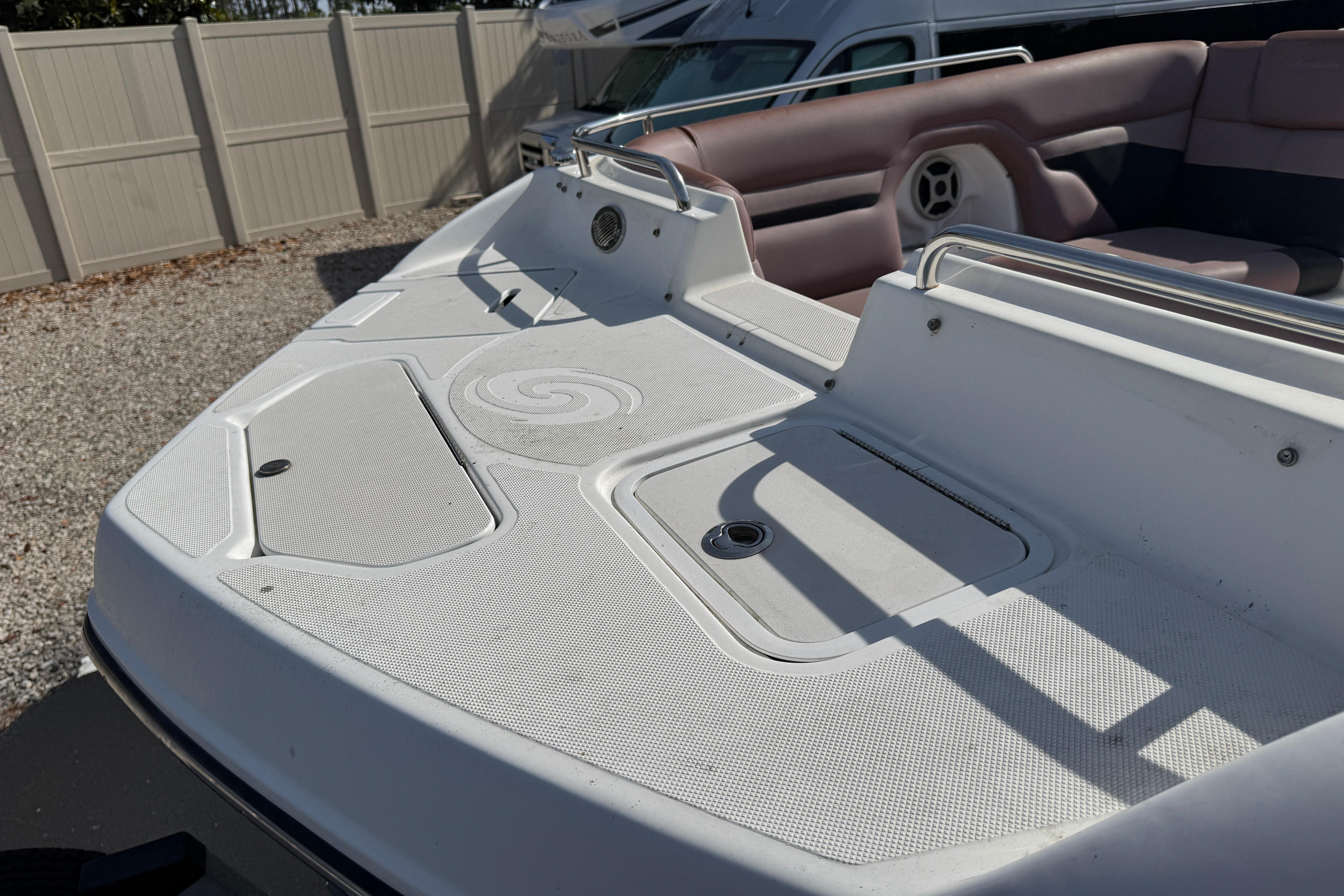 2018 Hurricane SunDeck 2400 OB boat deck with seating and storage compartments.