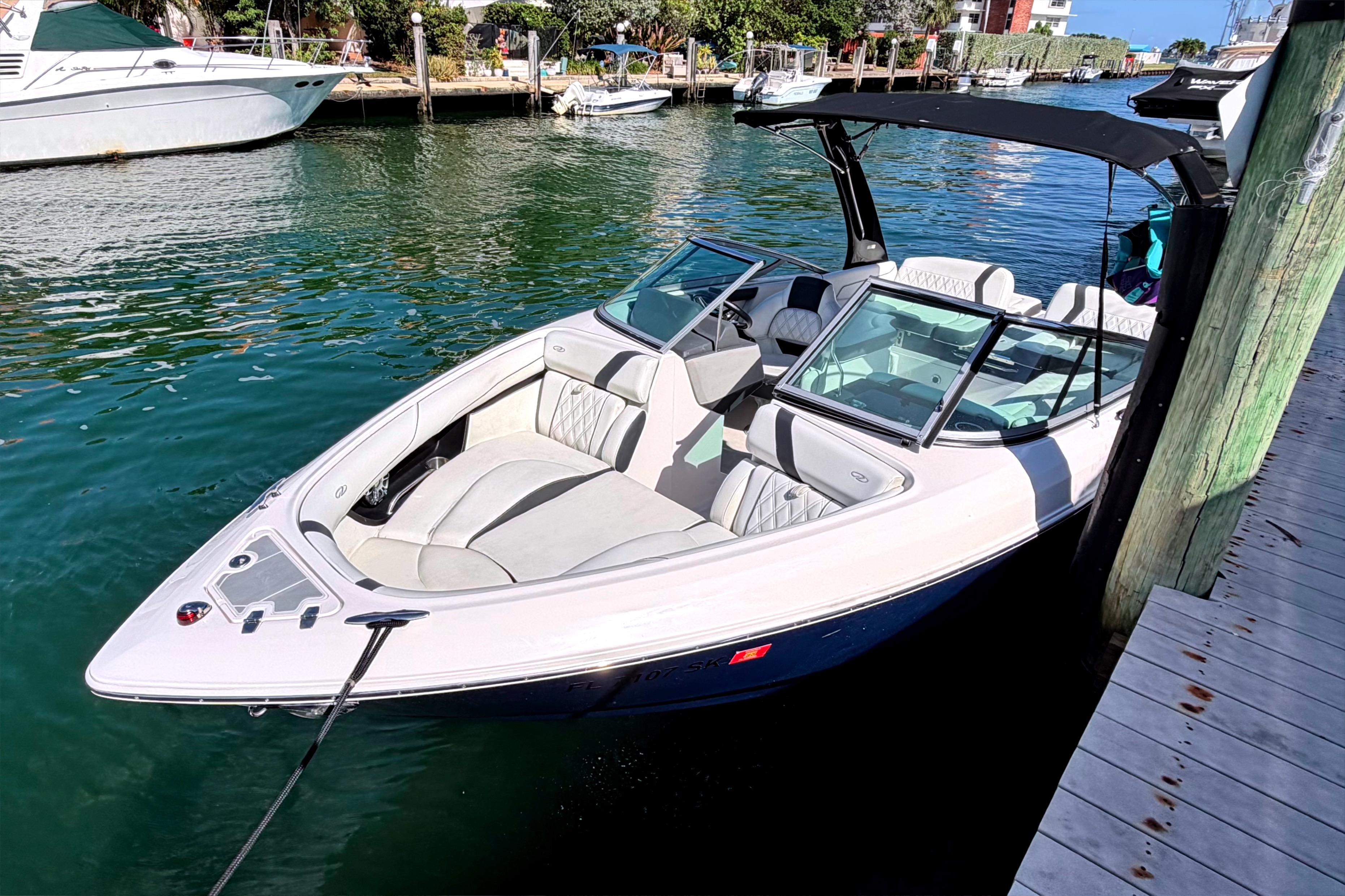 2020 Regal 2300 Bowrider docked in a marina, featuring sleek design and spacious seating.