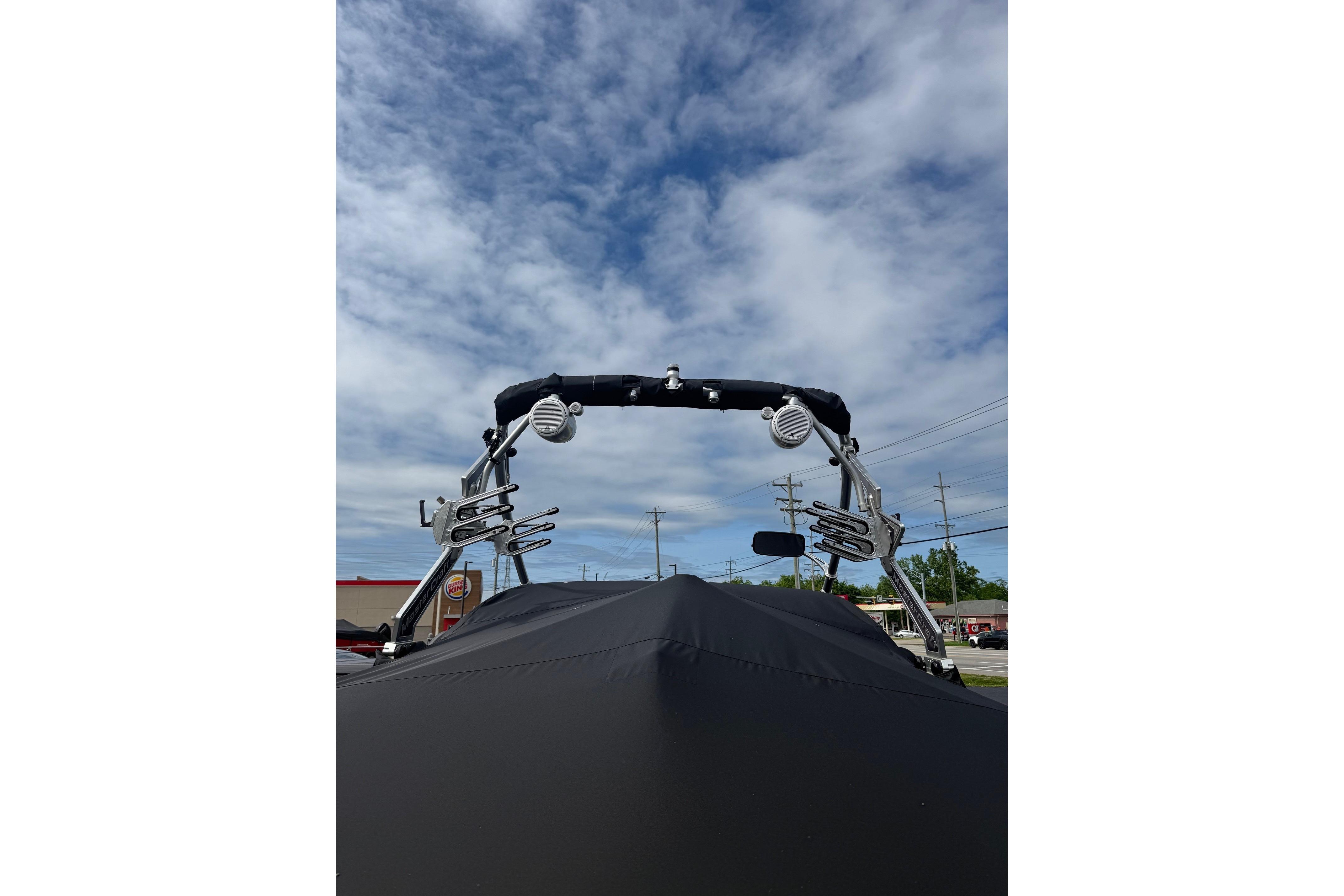 2008 MasterCraft X-15 boat with wakeboard tower against a cloudy sky.