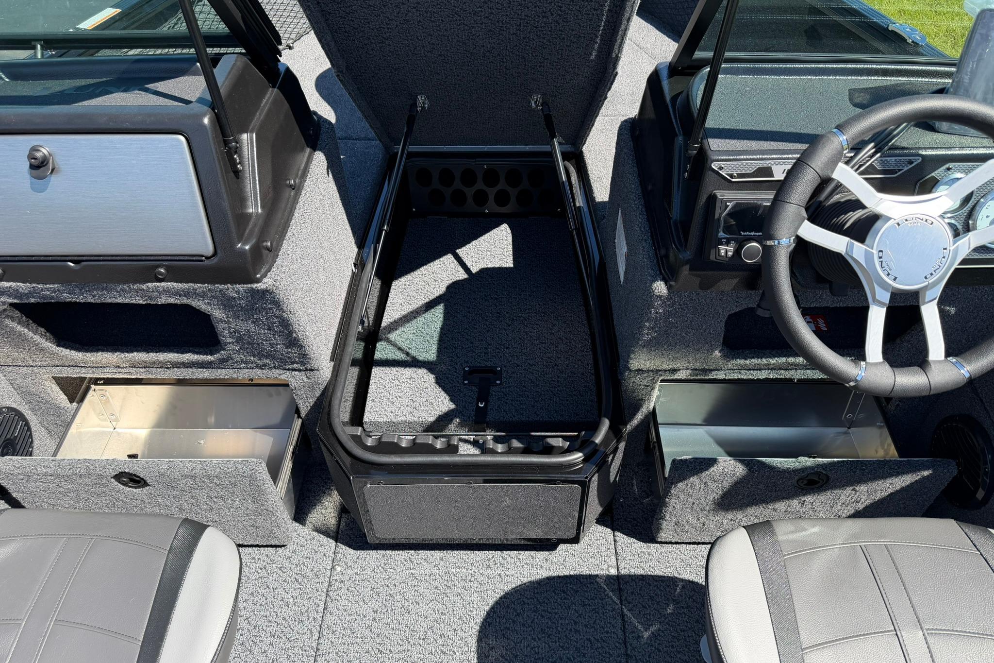2027 Lund 1775 Impact XS Sport boat interior with storage compartments and steering wheel.