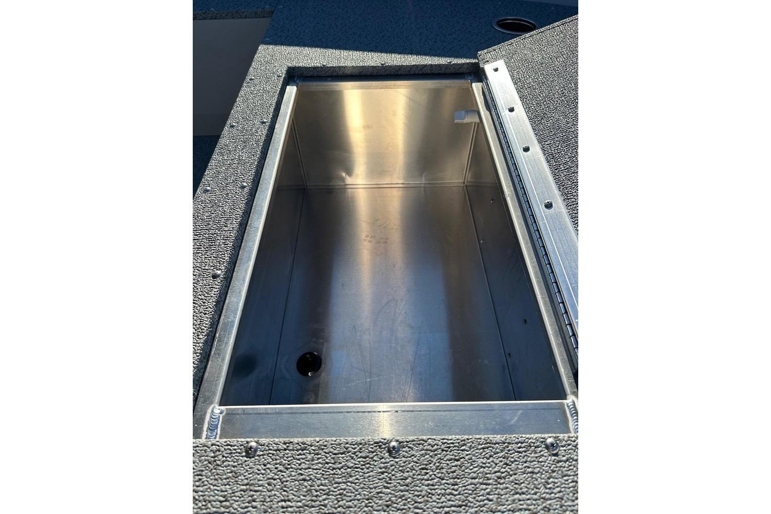 Open storage compartment in 2026 Smoker Craft Angler 16 SC boat.