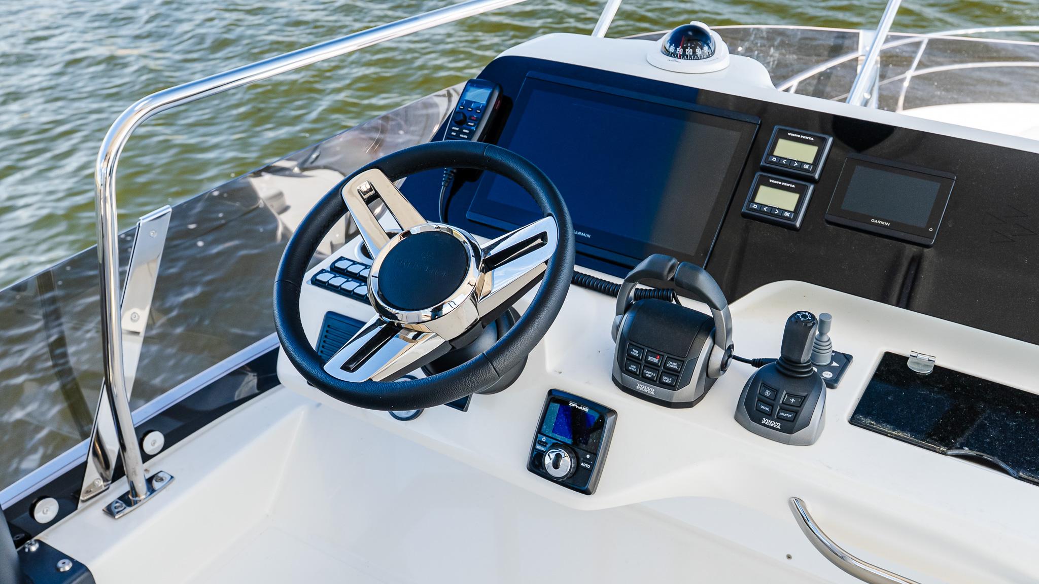 Helm of 2025 Prestige F4.9 boat with modern controls and navigation screens.