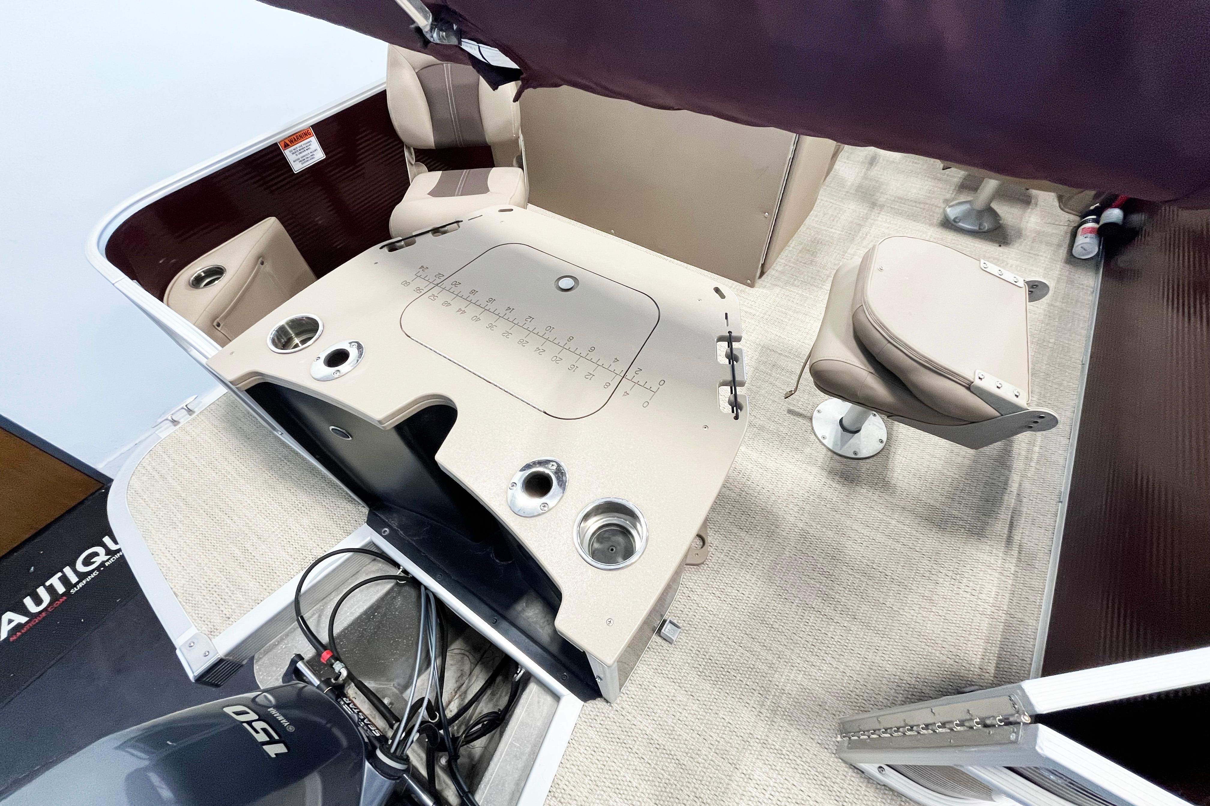 Interior of a 2020 Bennington SX25 boat featuring seating and control panel.