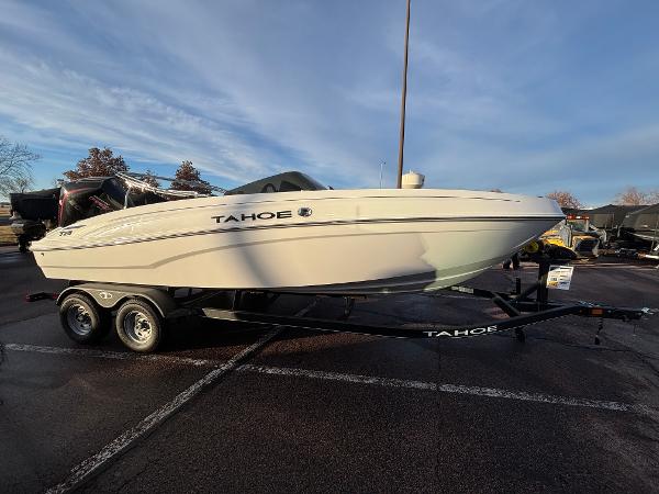 2024 Tahoe T21 boat on trailer in parking lot under cloudy sky.