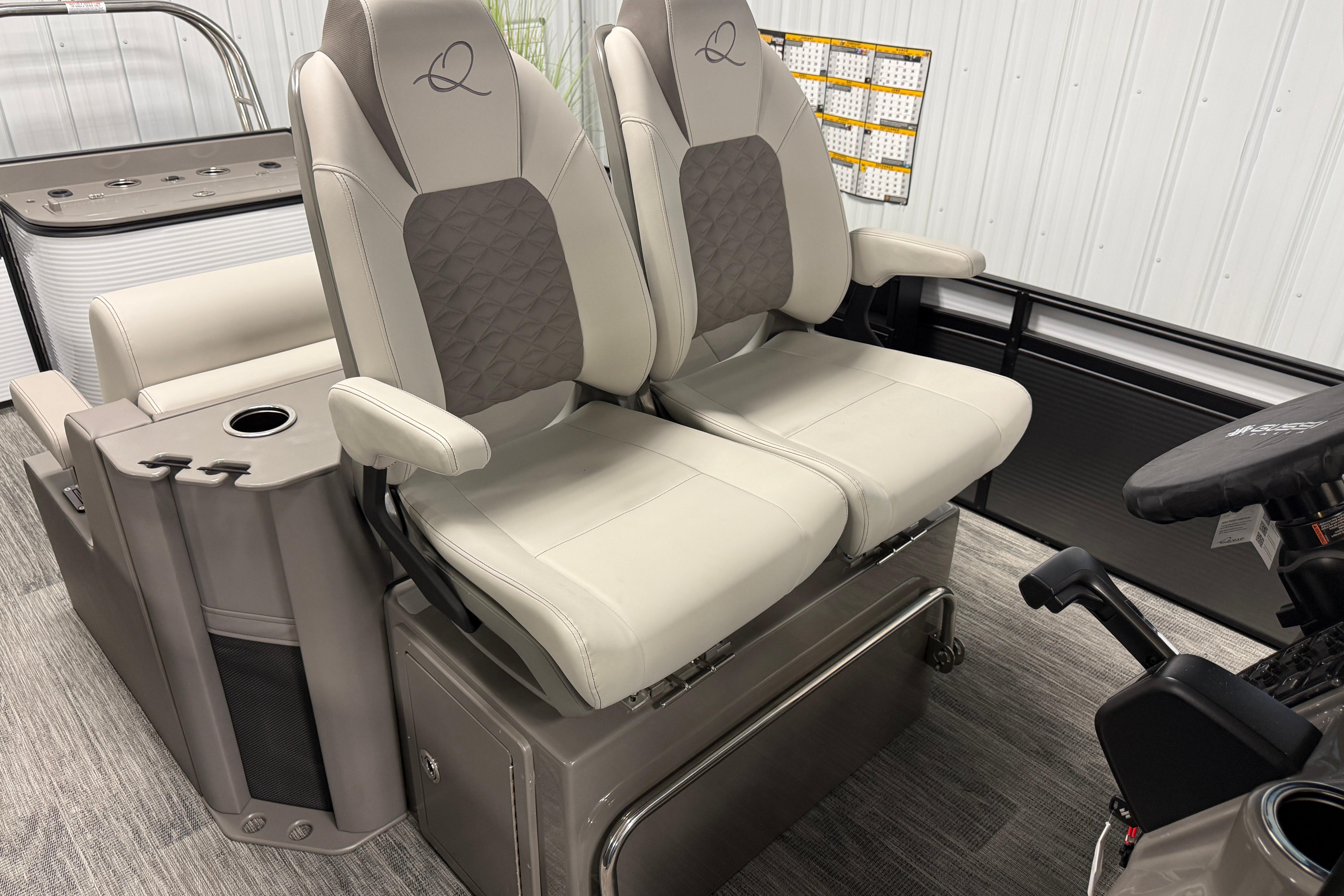 2026 Qwest M-Class 22 Pro Sport boat seats with armrests and storage compartment.