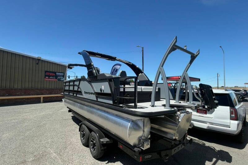 2026 Berkshire STS 23 Ultra Lounger SportArch pontoon boat on trailer, outdoor setting.