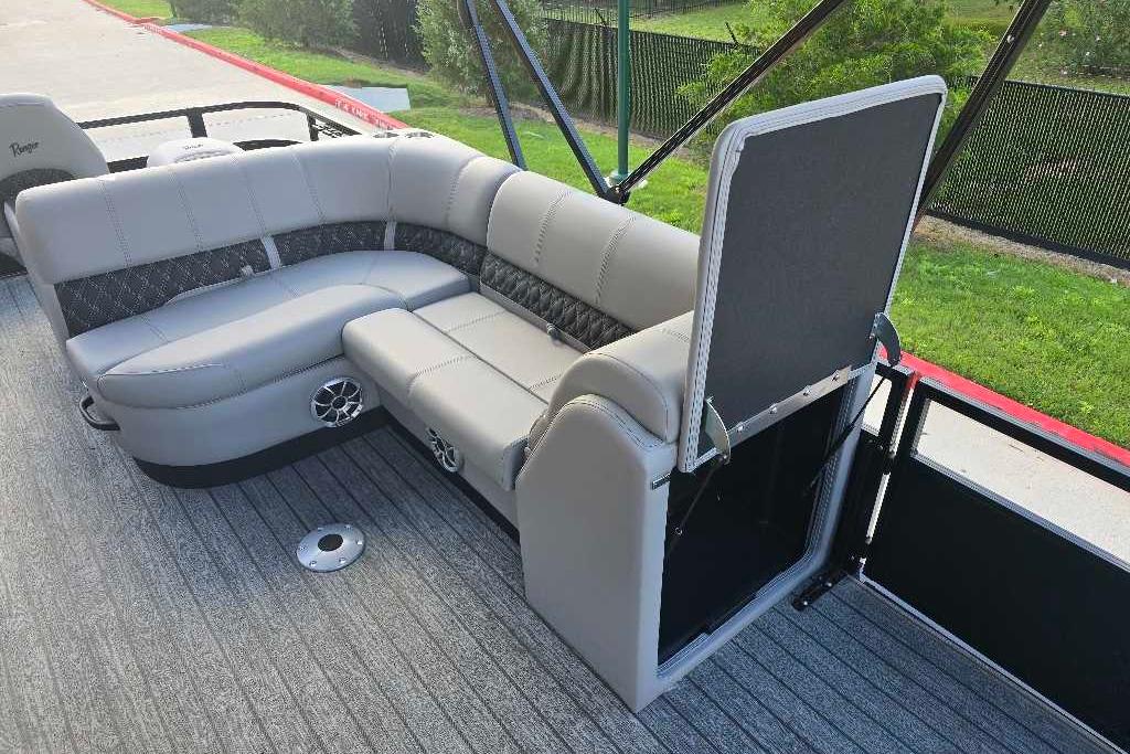 2026 Ranger 223FC boat interior with gray seating and storage compartment open.